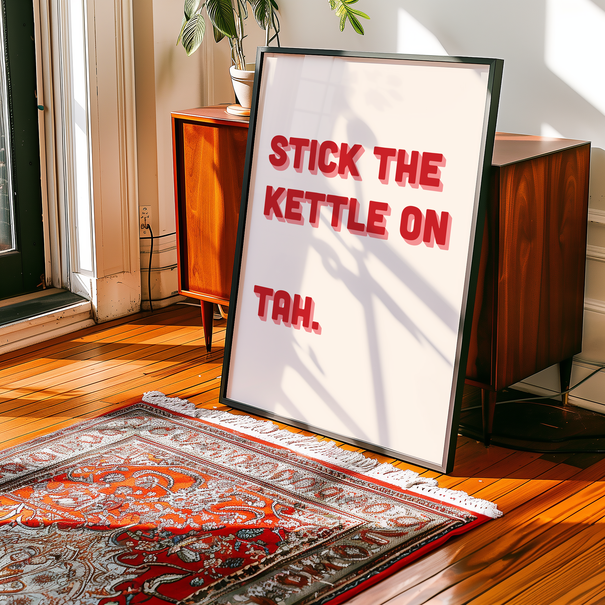 Funny quote print poster that says "Stick the Kettle On Tah" in two tone retro red and pink font. British humour poster