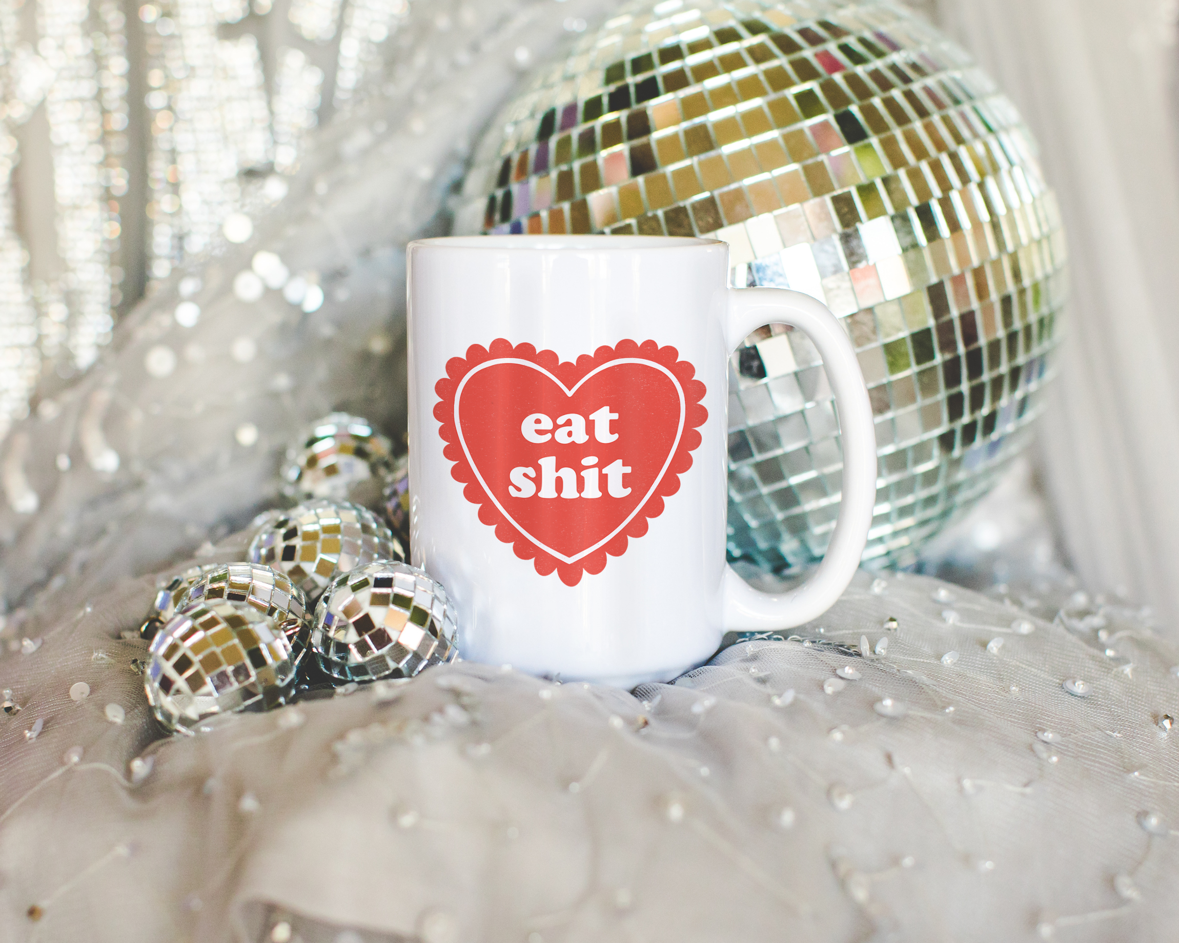 Sassy dopamine decor White coffee mug that says "Eat shit" in a retro vintage style frilly heart that's red with a retro font.. Available in 11oz and 15oz
