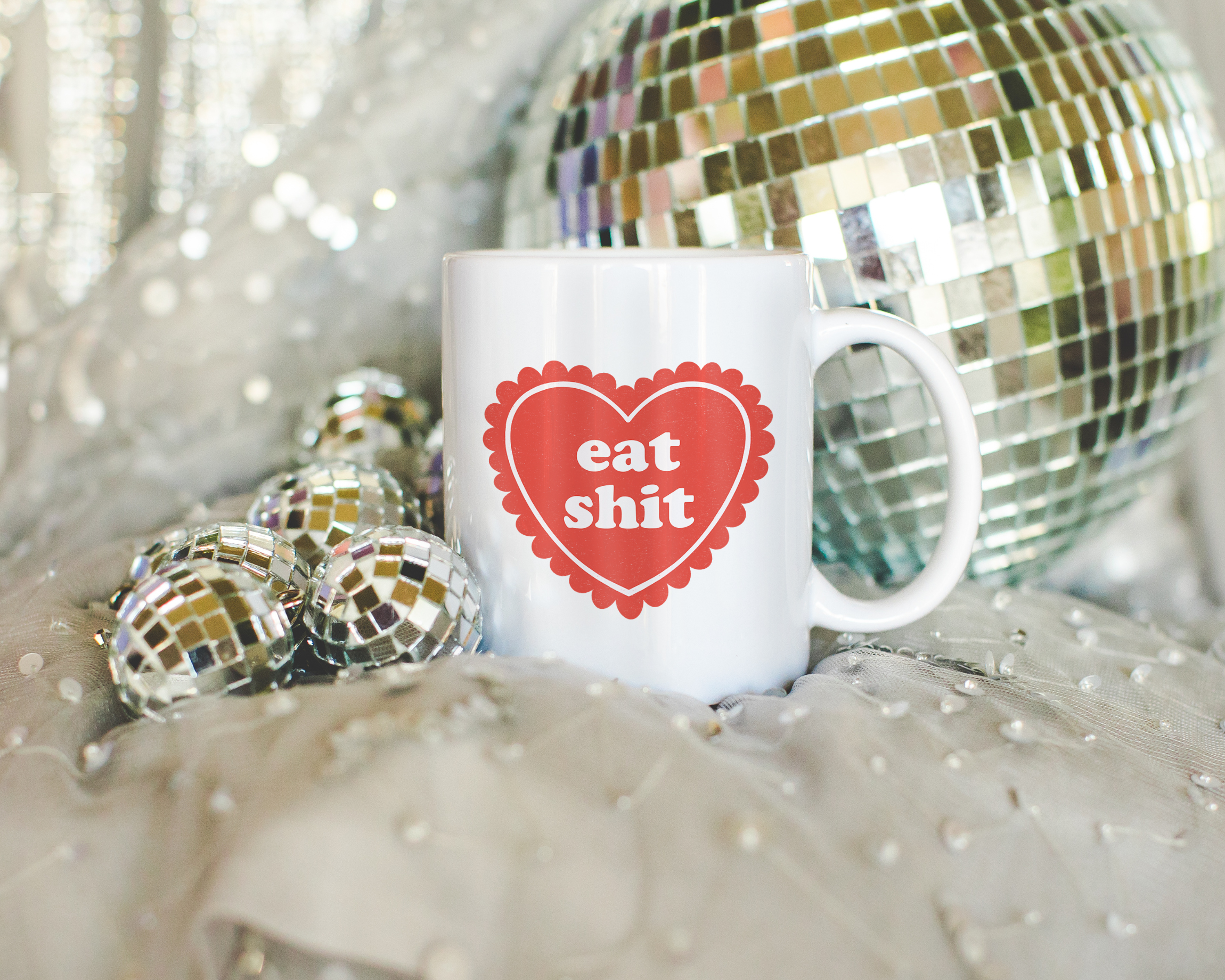 Sassy dopamine decor White coffee mug that says "Eat shit" in a retro vintage style frilly heart that's red with a retro font.. Available in 11oz and 15oz