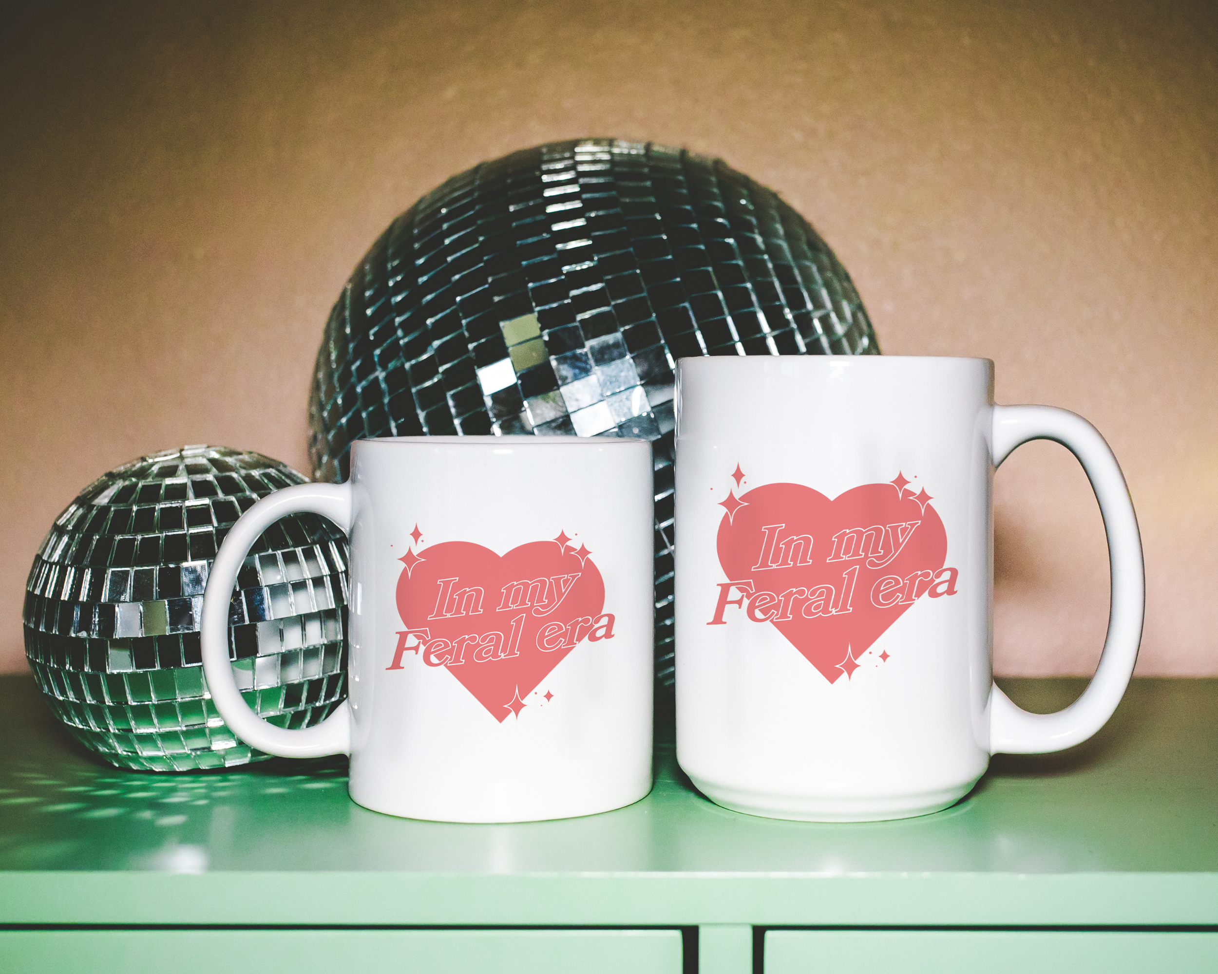 Sassy dopamine decor White coffee mug that says "In my feral era" in a retro vintage style heart that's pink with a retro font.. Available in 11oz and 15oz