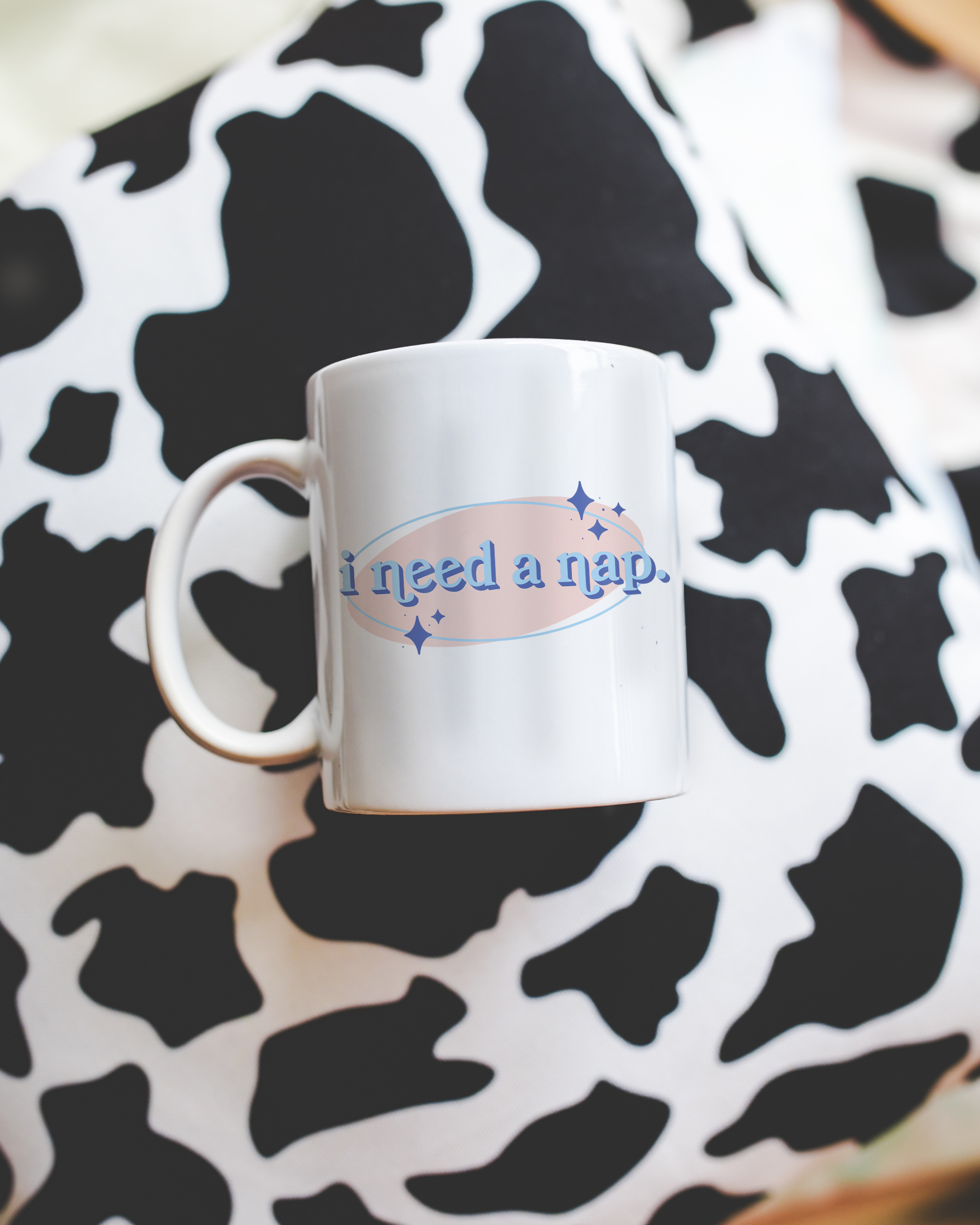White coffee mug that says "I need a nap" in a retro vintage font that's blue and pink. Available in 11oz and 15oz