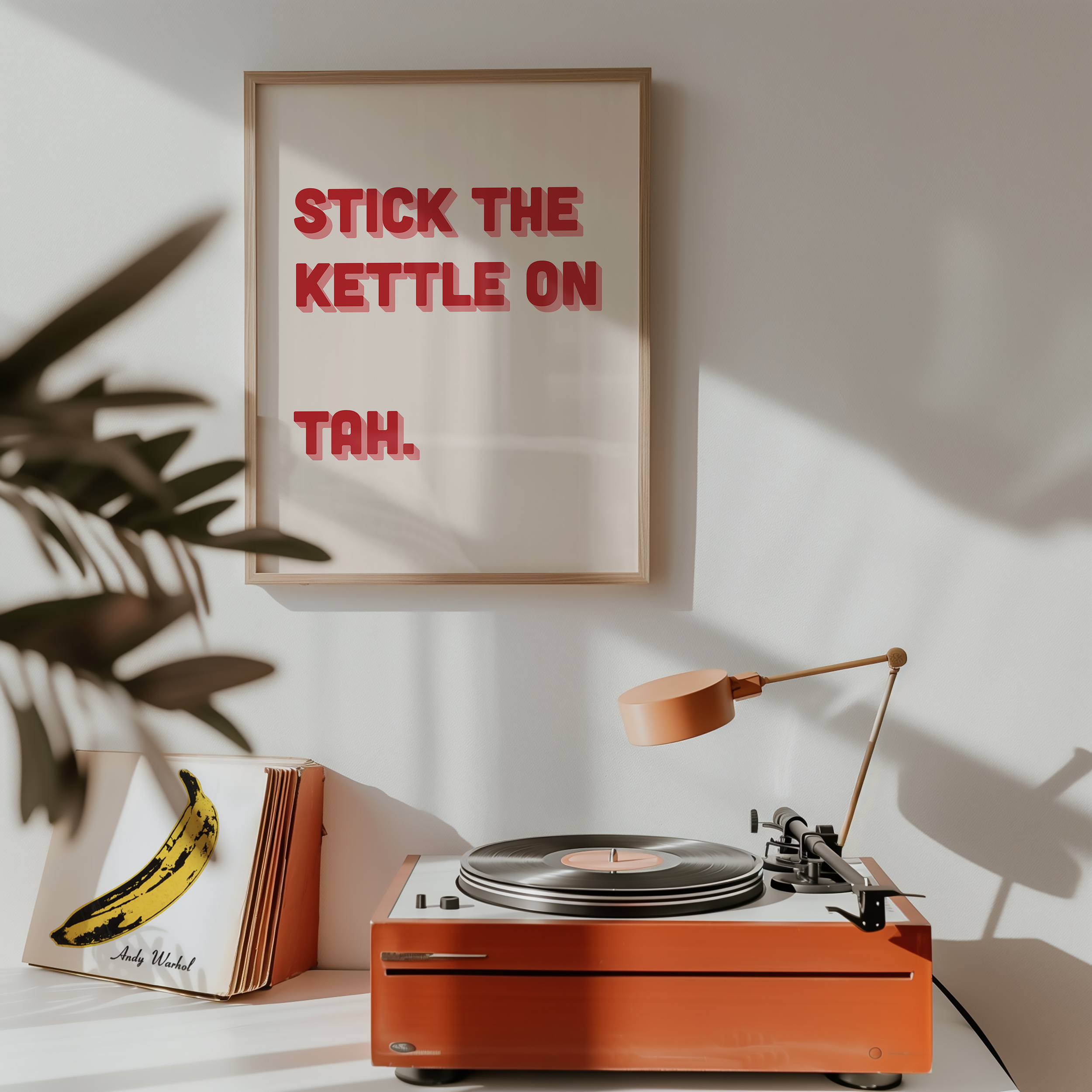Funny quote print poster that says "Stick the Kettle On Tah" in two tone retro red and pink font. British humour poster