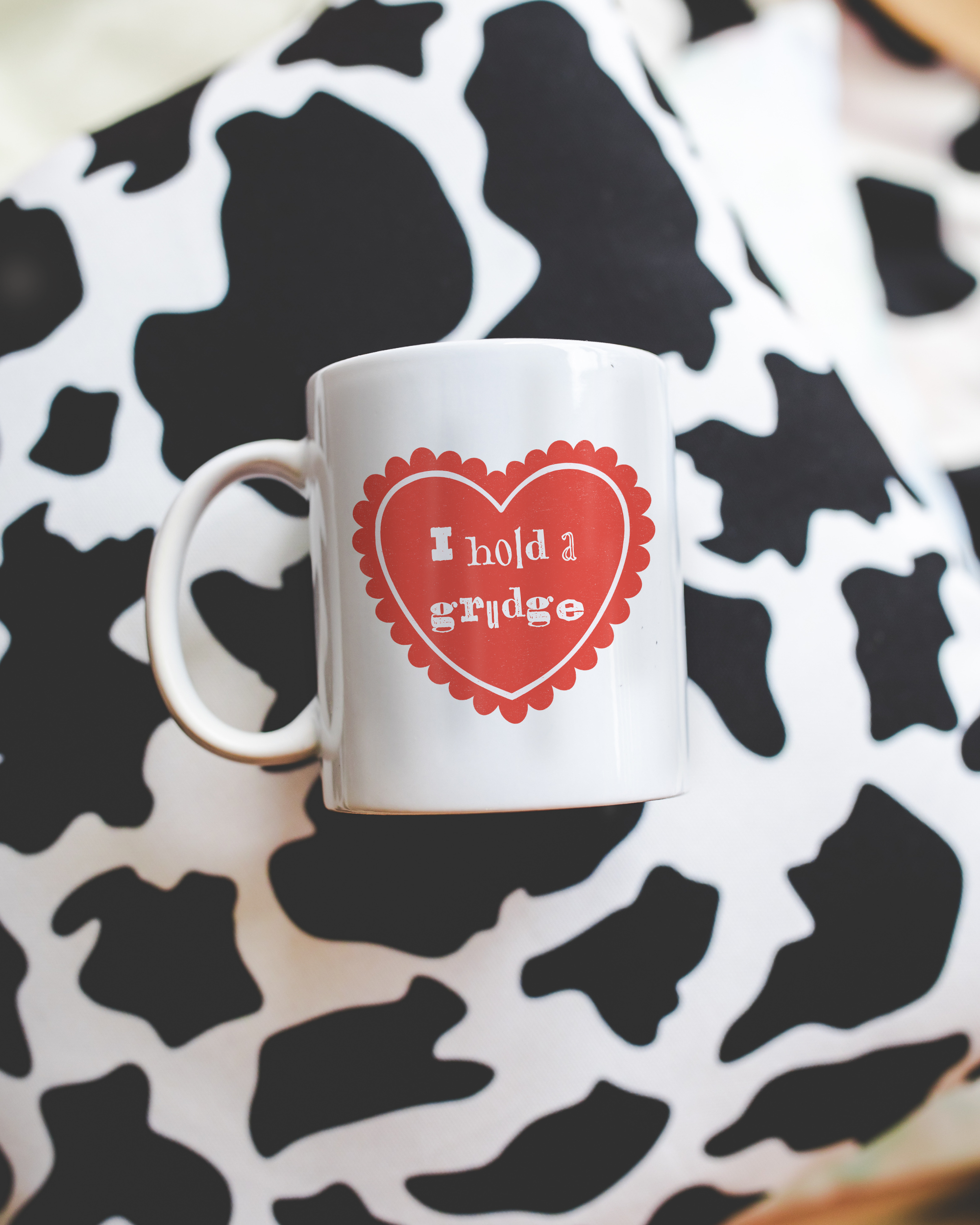 Sassy dopamine decor White coffee mug that says "I hold a grudge" in a retro vintage style frilly heart that's red with a retro font.. Available in 11oz and 15oz