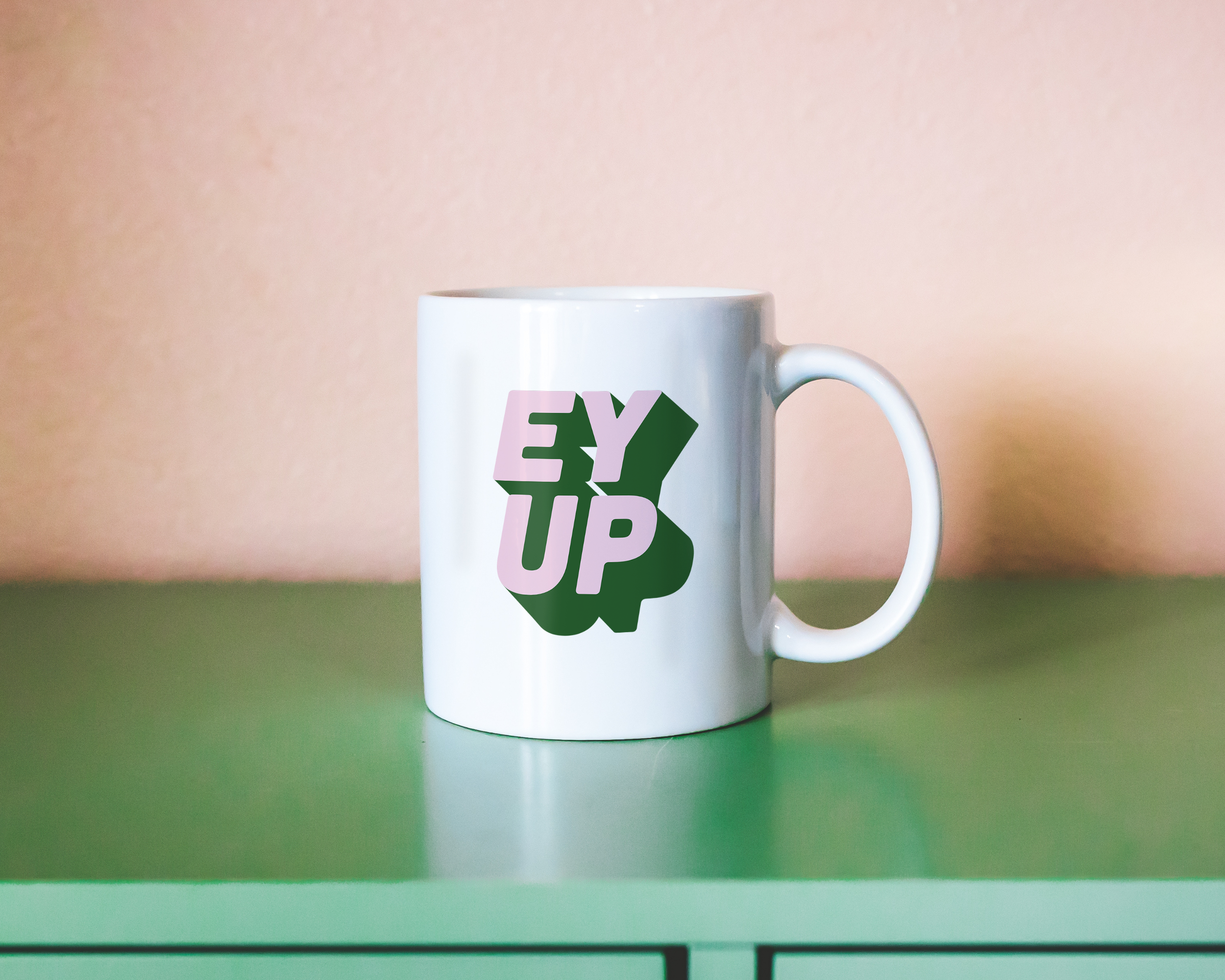 Sassy dopamine decor White coffee mug that says "ey up" in a retro two tone vintage style pink and green font. Available in 11oz and 15oz. British humour