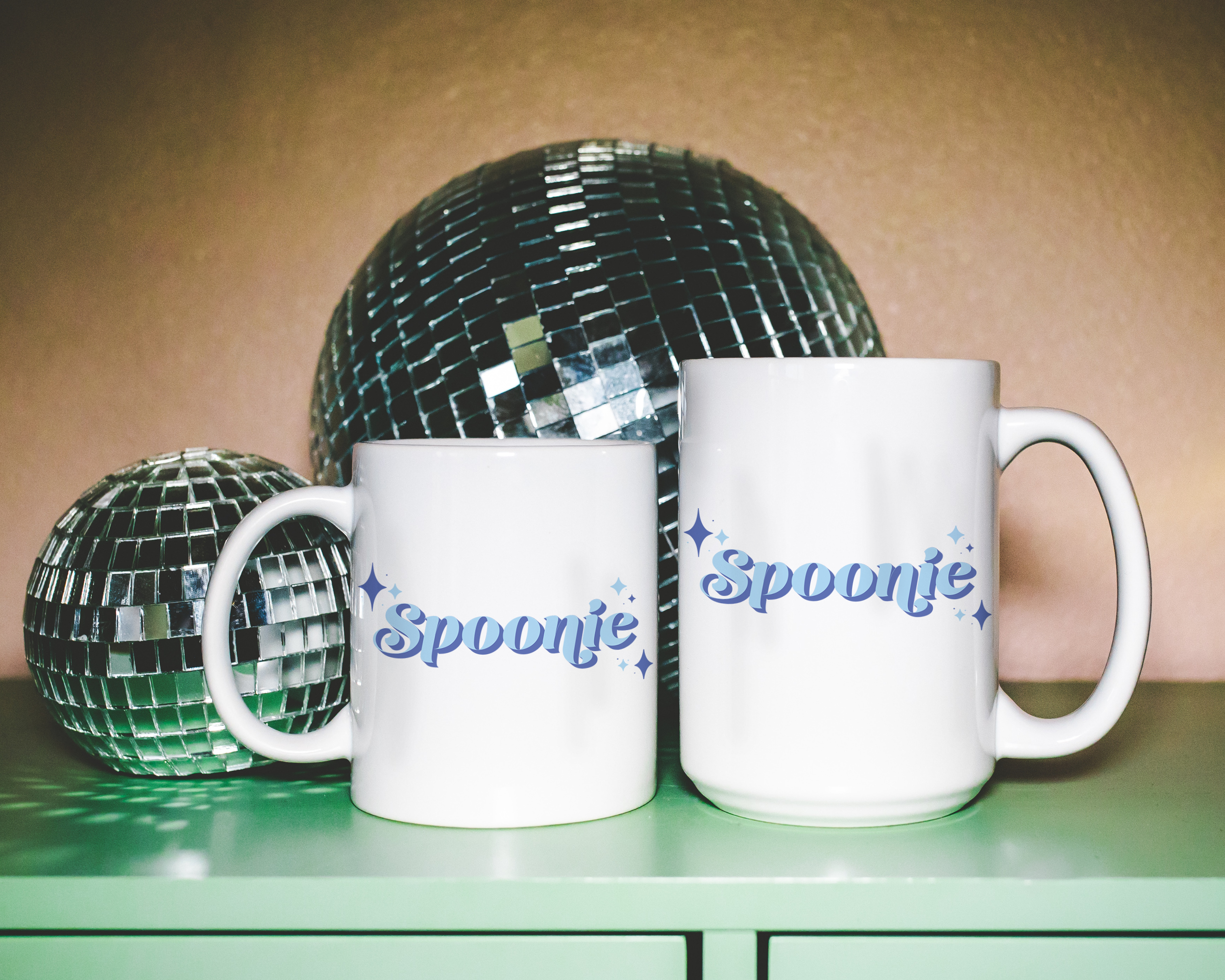 Sassy dopamine decor White coffee mug that says "Spoonie" in a retro vintage style blue font. Available in 11oz and 15oz
