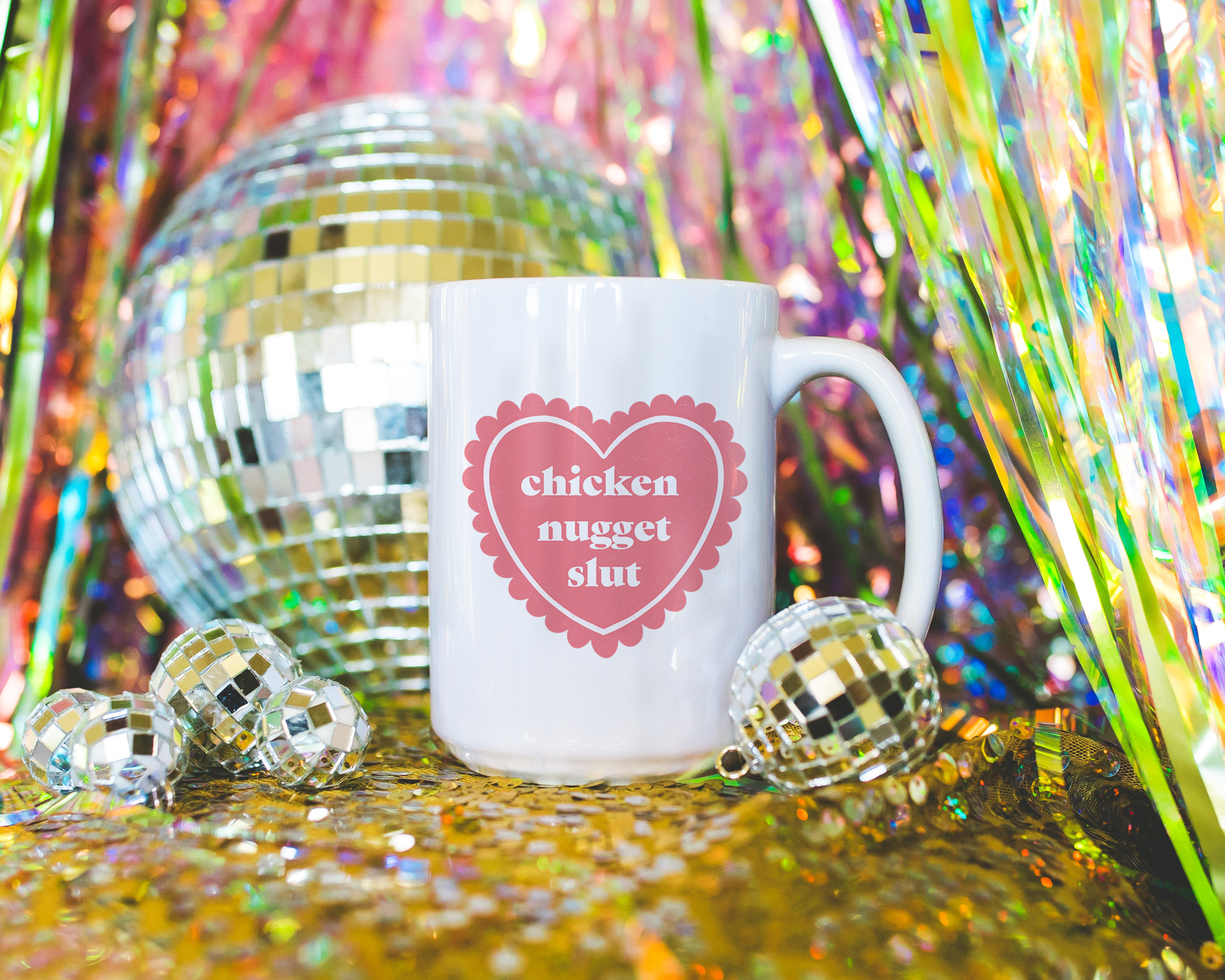 Sassy dopamine decor White coffee mug that says "chicken nugget slut" in a retro vintage style frilly heart that's pink with a retro font.. Available in 11oz and 15oz