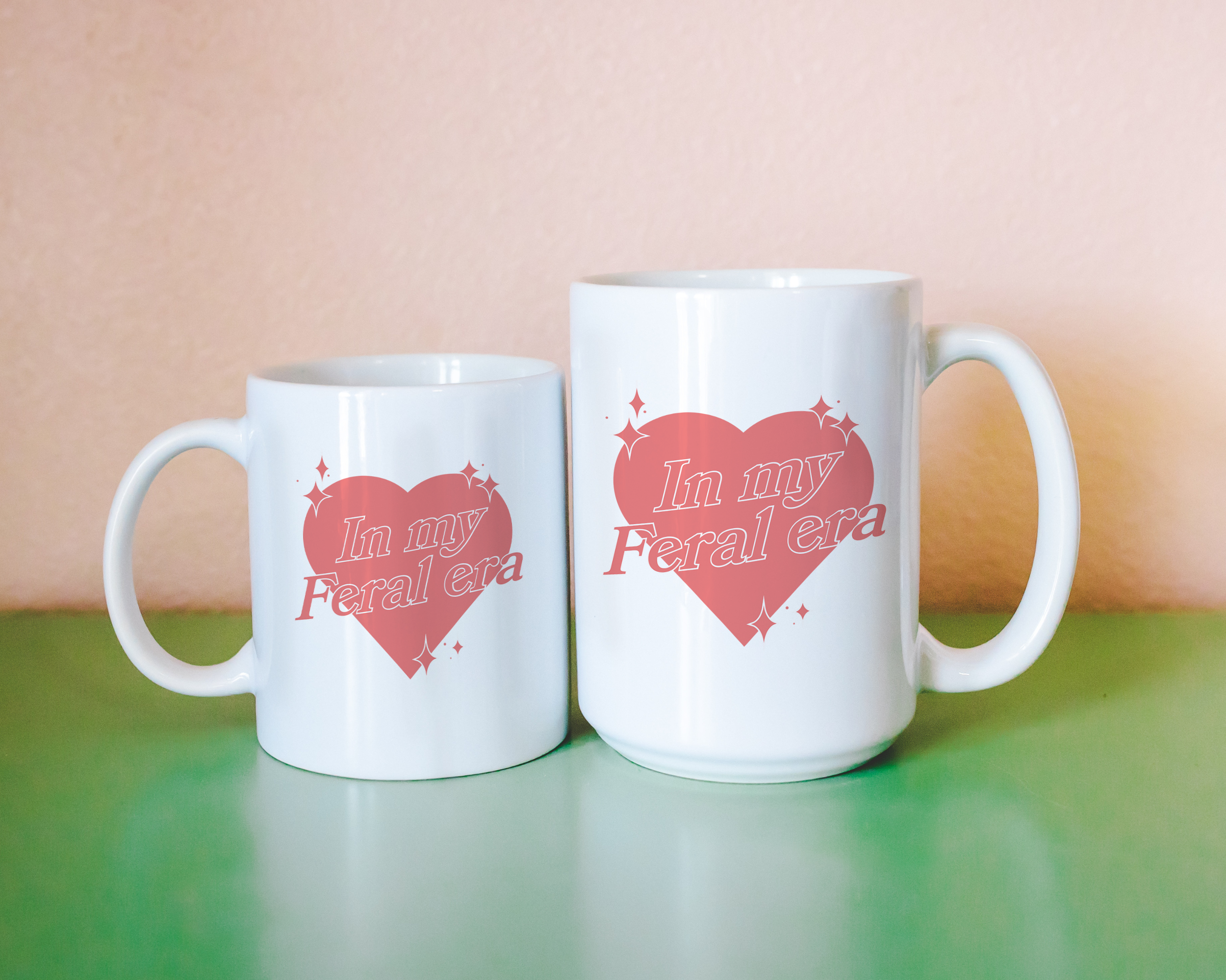 Sassy dopamine decor White coffee mug that says "In my feral era" in a retro vintage style heart that's pink with a retro font.. Available in 11oz and 15oz