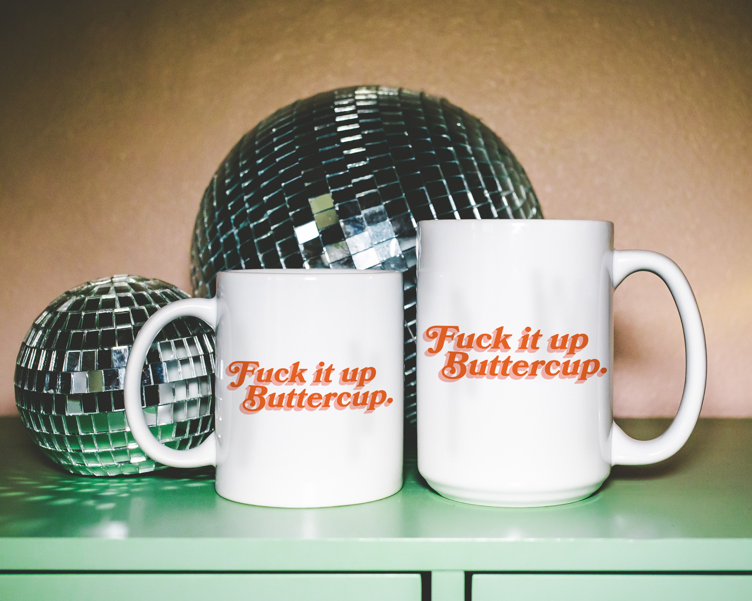 Sassy dopamine decor White coffee mug that says "Fuck it up buttercup" in a retro vintage font that's orange. Available in 11oz and 15oz