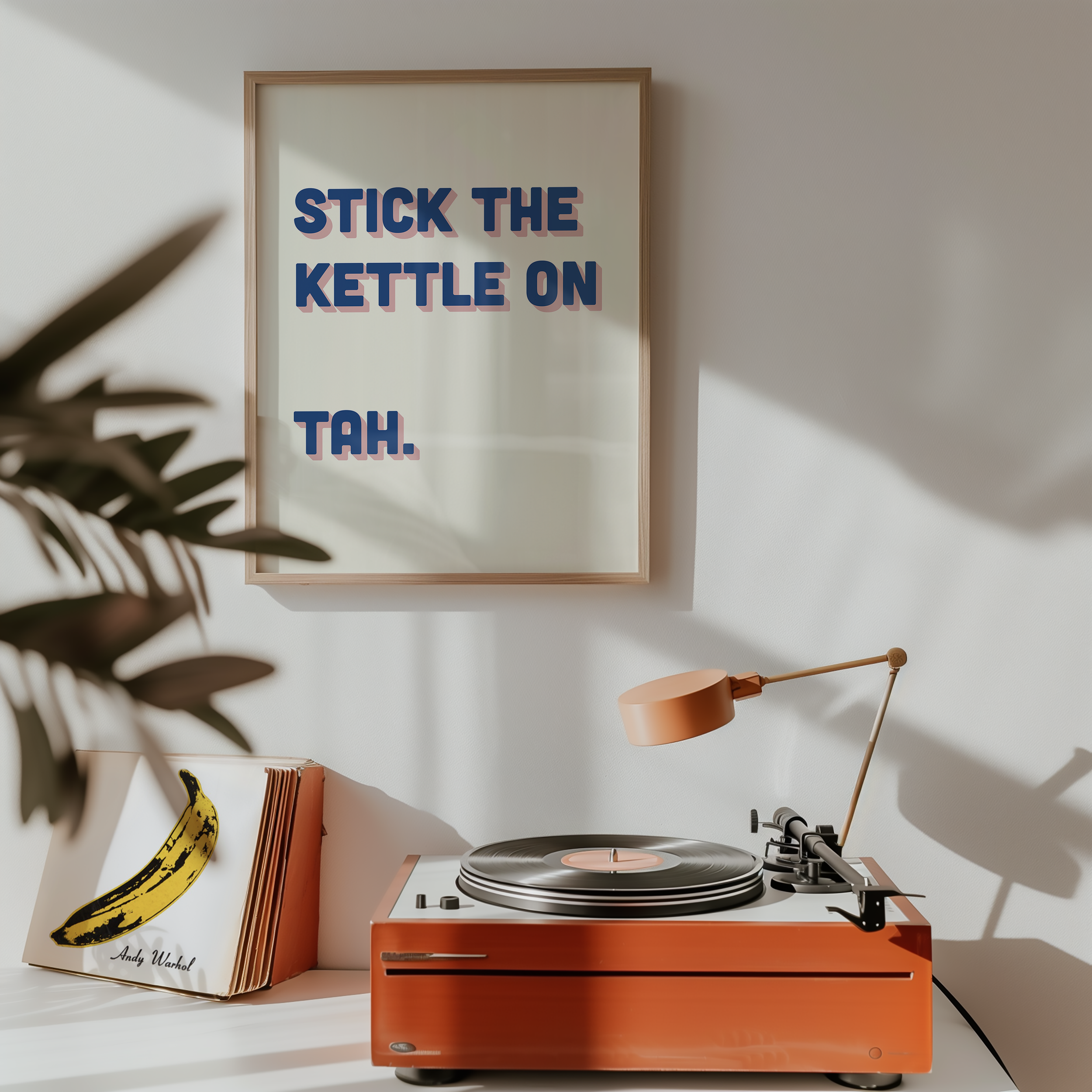 Funny quote print poster that says "Stick the Kettle On Tah" in two tone retro blue and pink font. British humour poster