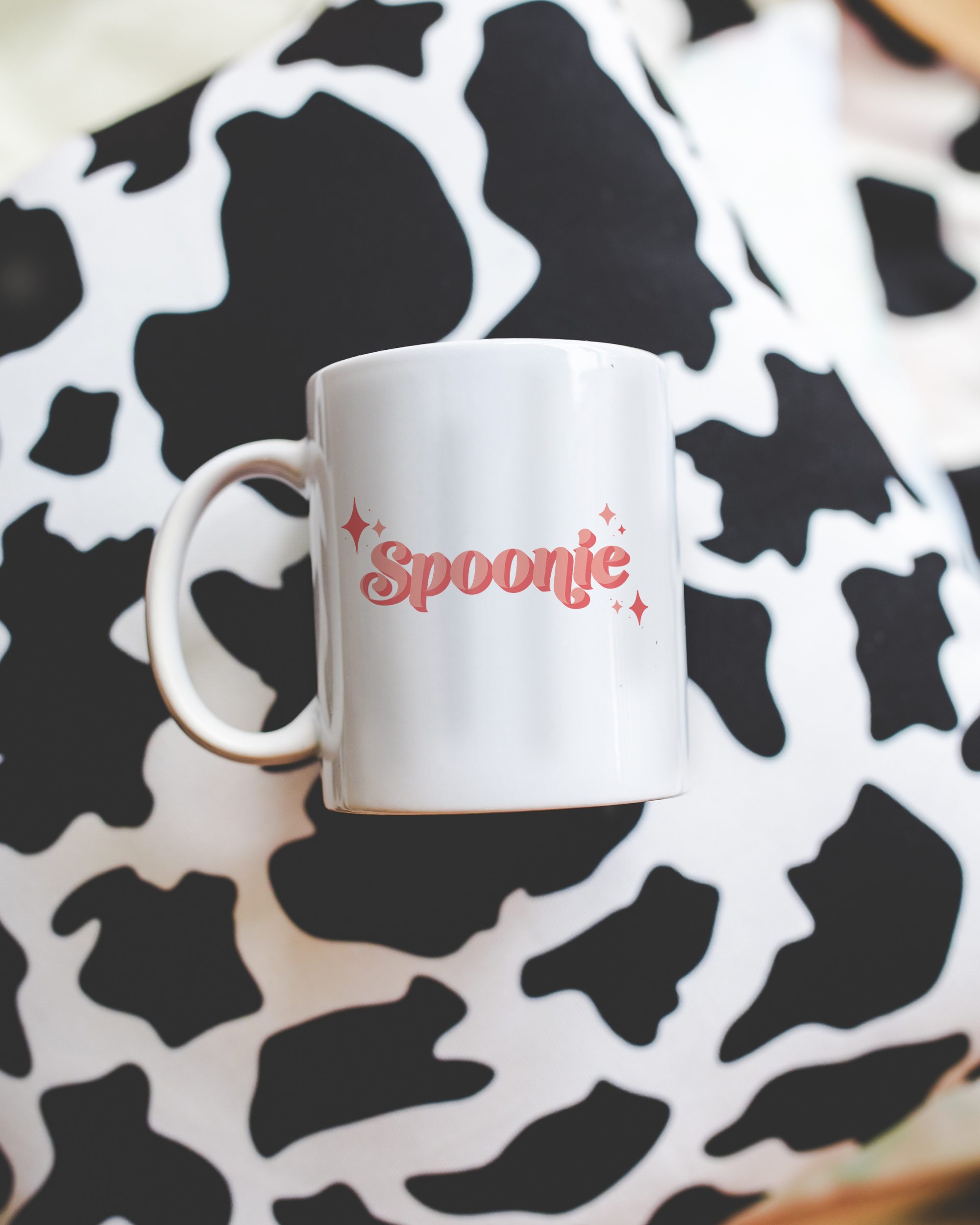 Sassy dopamine decor White coffee mug that says "Spoonie" in a retro vintage style pink font. Available in 11oz and 15oz