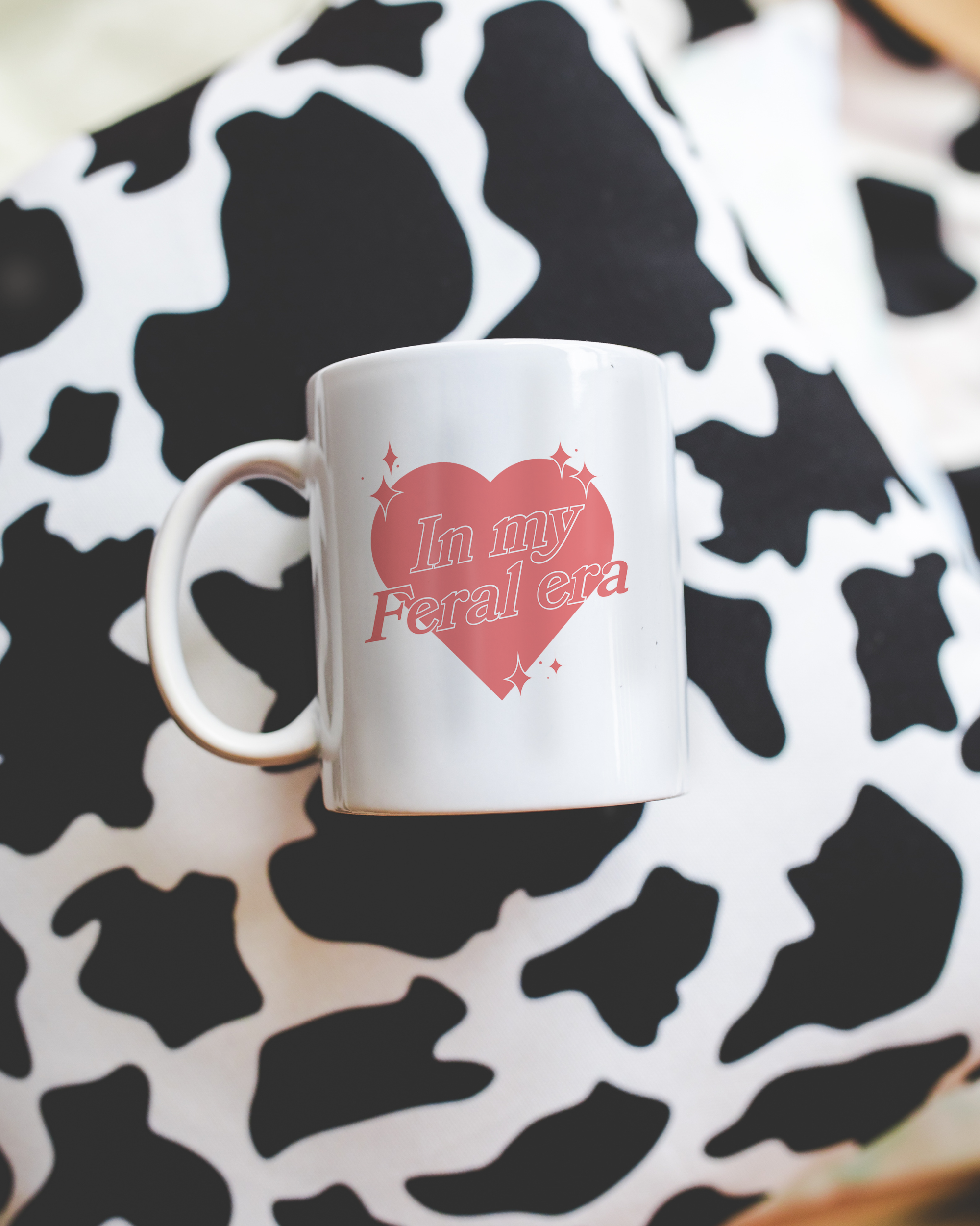 Sassy dopamine decor White coffee mug that says "In my feral era" in a retro vintage style heart that's pink with a retro font.. Available in 11oz and 15oz