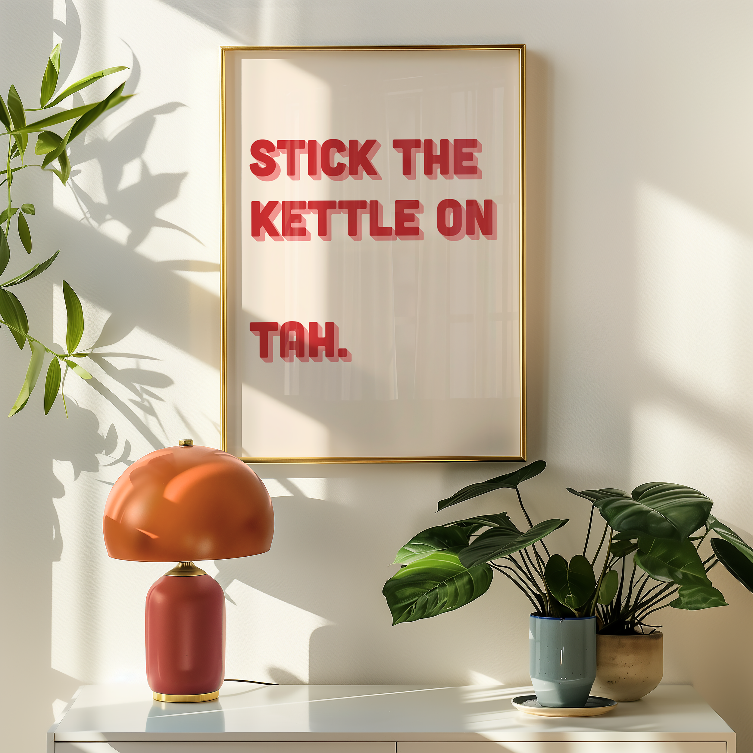 Funny quote print poster that says "Stick the Kettle On Tah" in two tone retro red and pink font. British humour poster