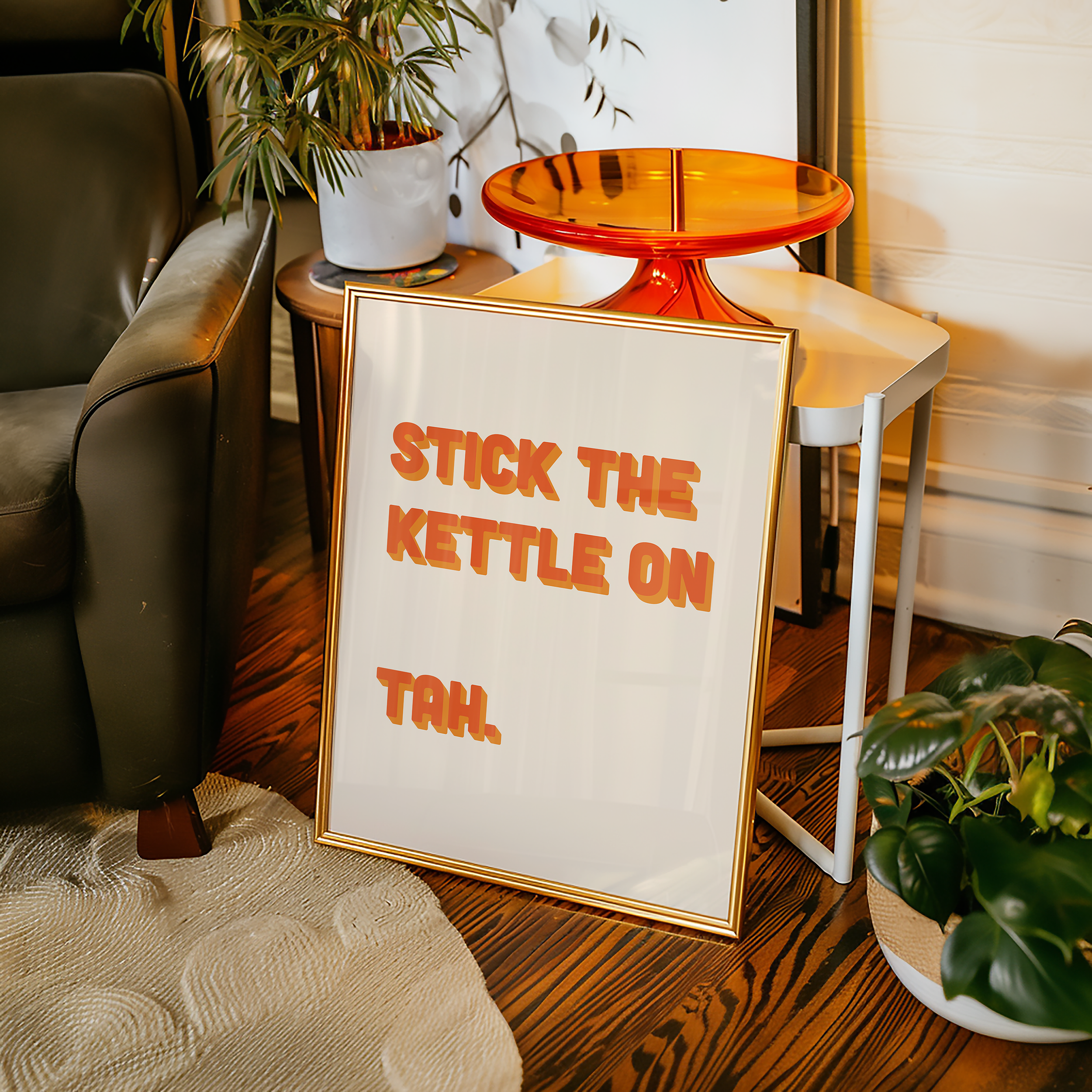 Funny quote print poster that says "Stick the Kettle On Tah" in two tone retro orange font. British humour poster