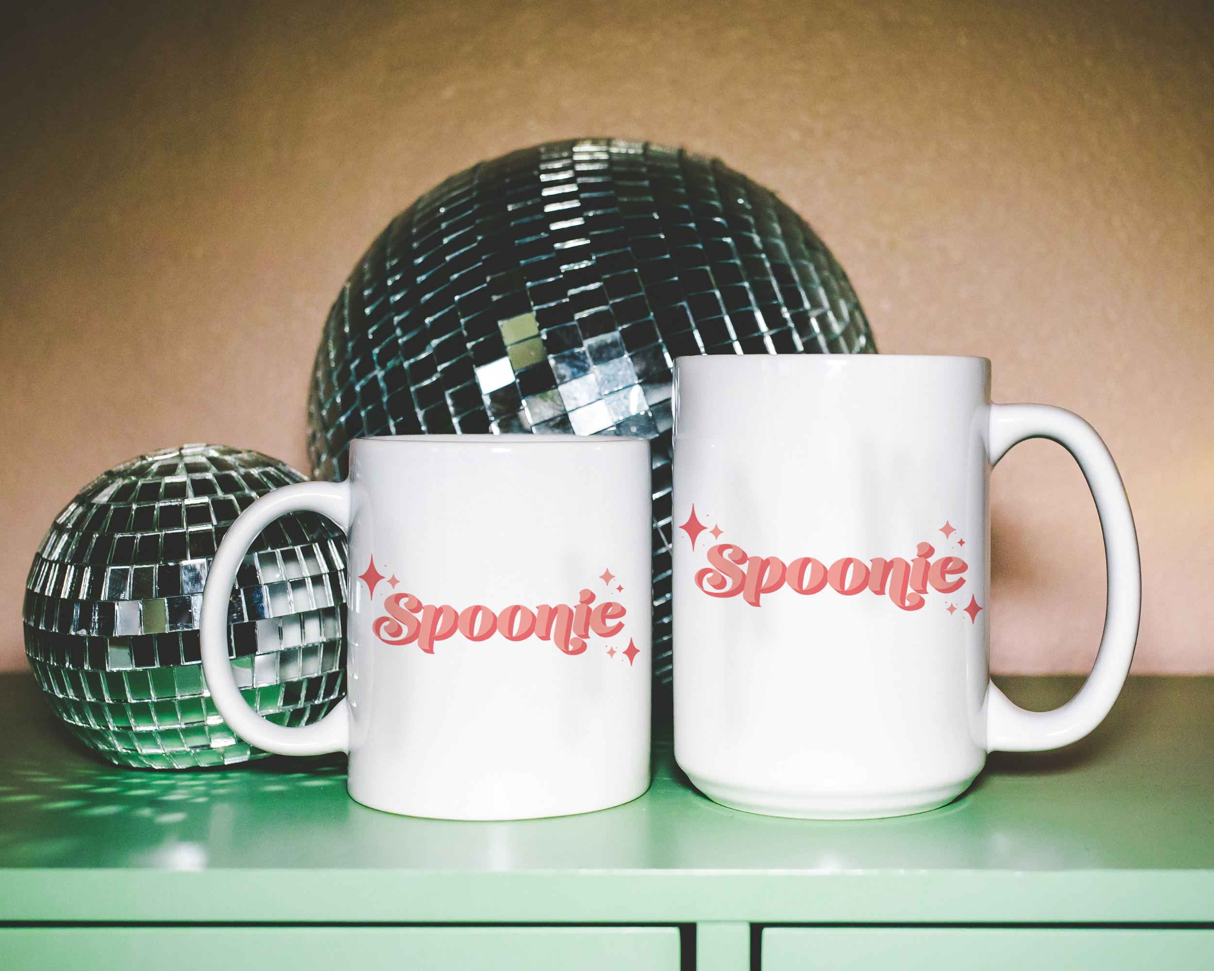 Sassy dopamine decor White coffee mug that says "Spoonie" in a retro vintage style pink font. Available in 11oz and 15oz