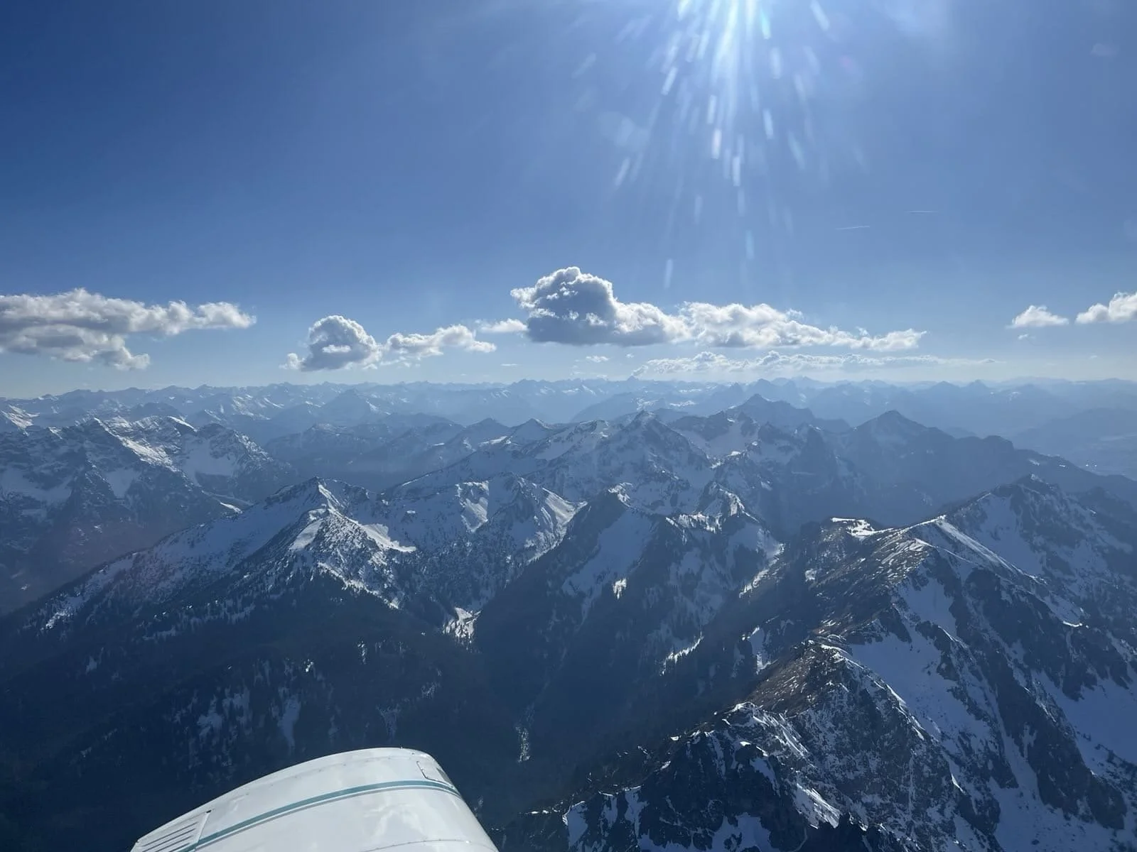 View of snow-capped mountains from an airplane.