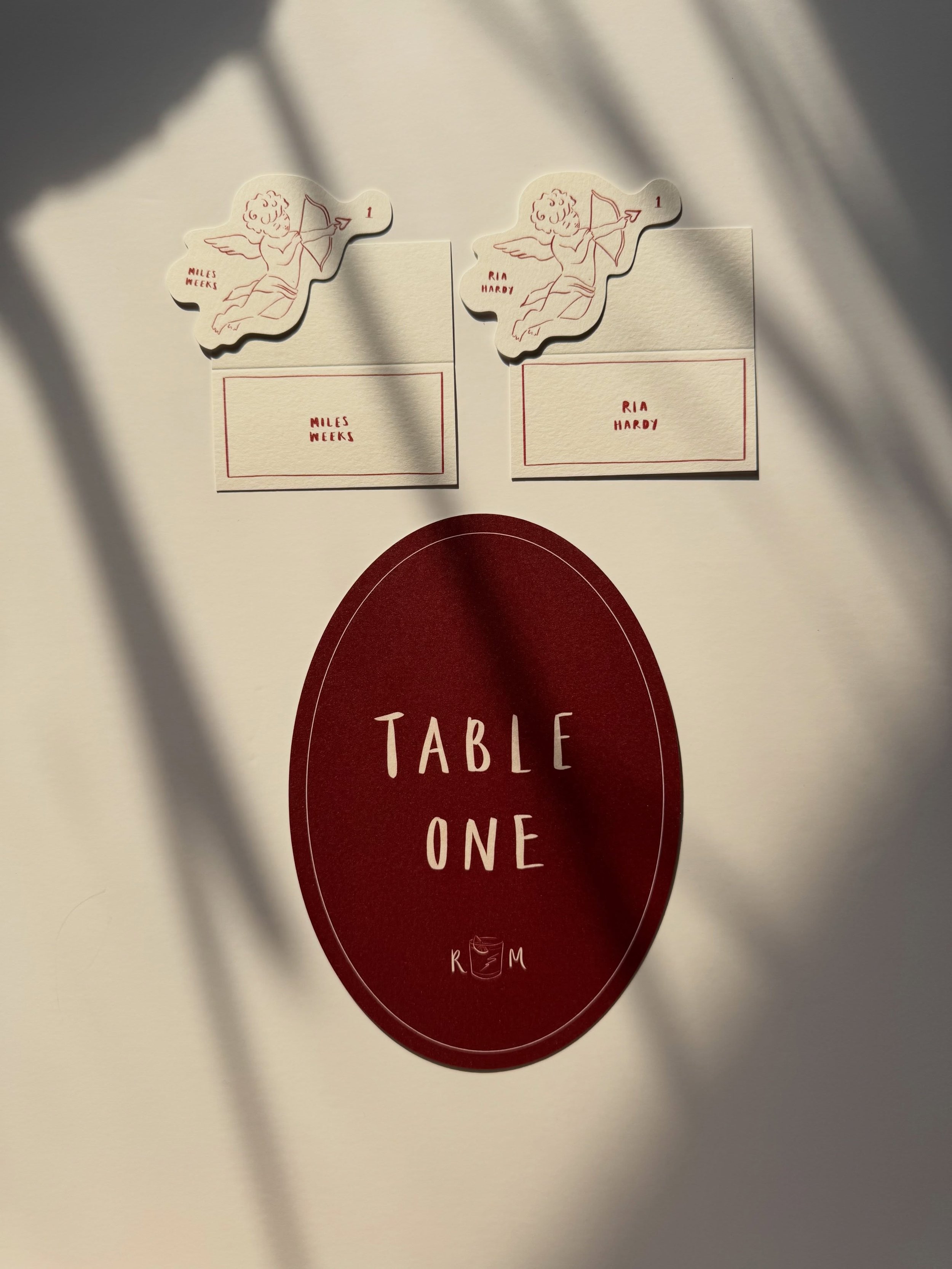 Hand lettered table names and with a spicy marg monogram, cherub escort cards &amp; hand lettered placenames for Ria &amp; Miles 🏹🤍🪽