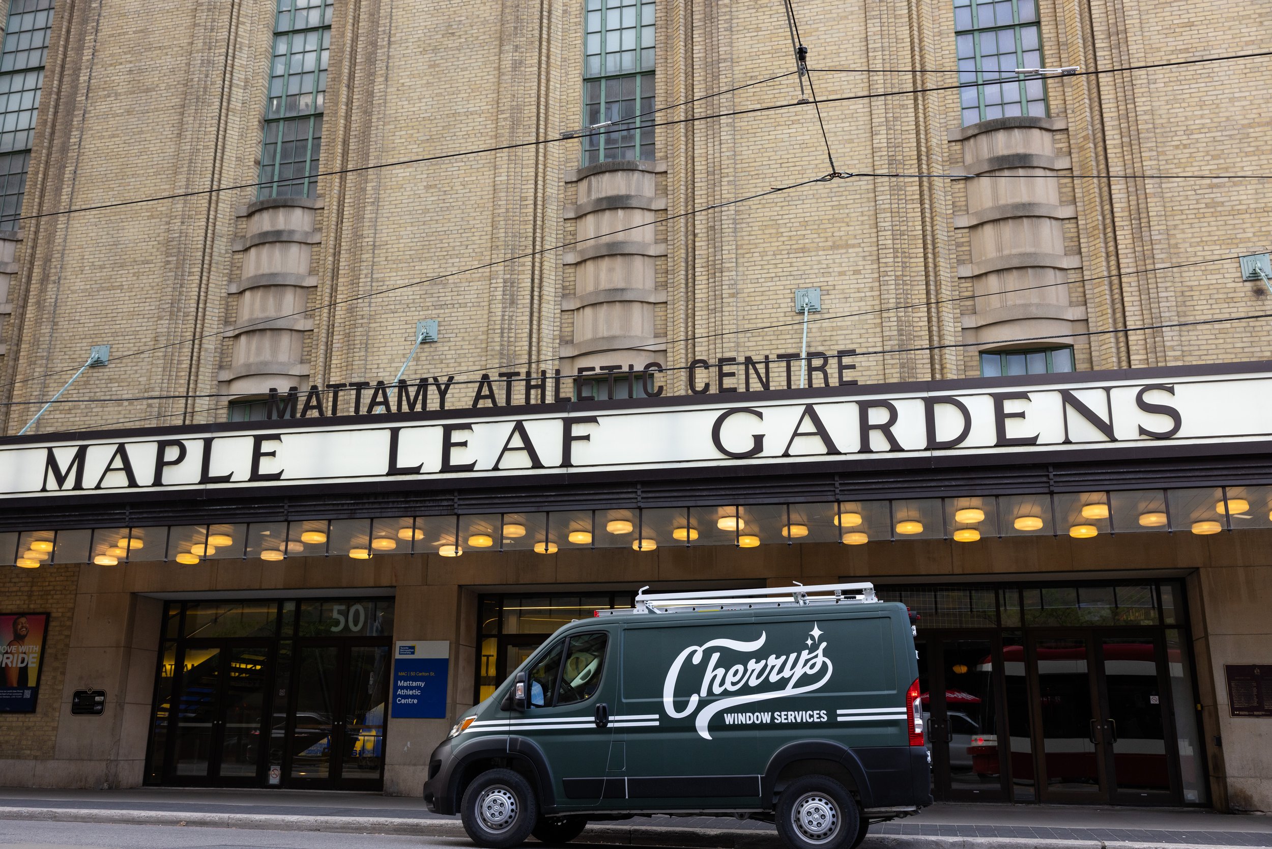 The exterior of the Mattamy Athletic Centre at Maple Leaf Gardens with a green Cherry's Window Services truck parked outside.