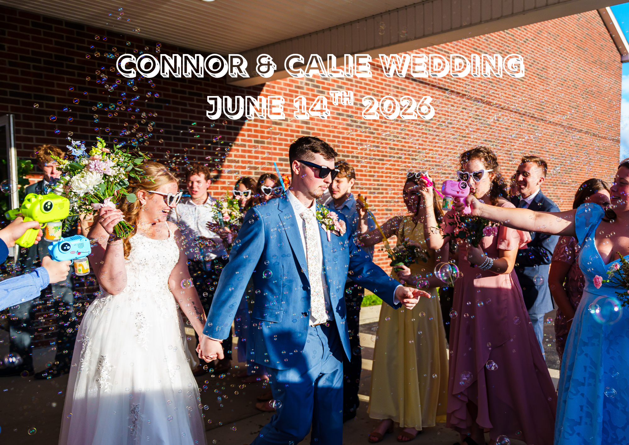 Wedding celebration with guests in colorful dresses and suits, blowing bubbles outside under a clear sky.