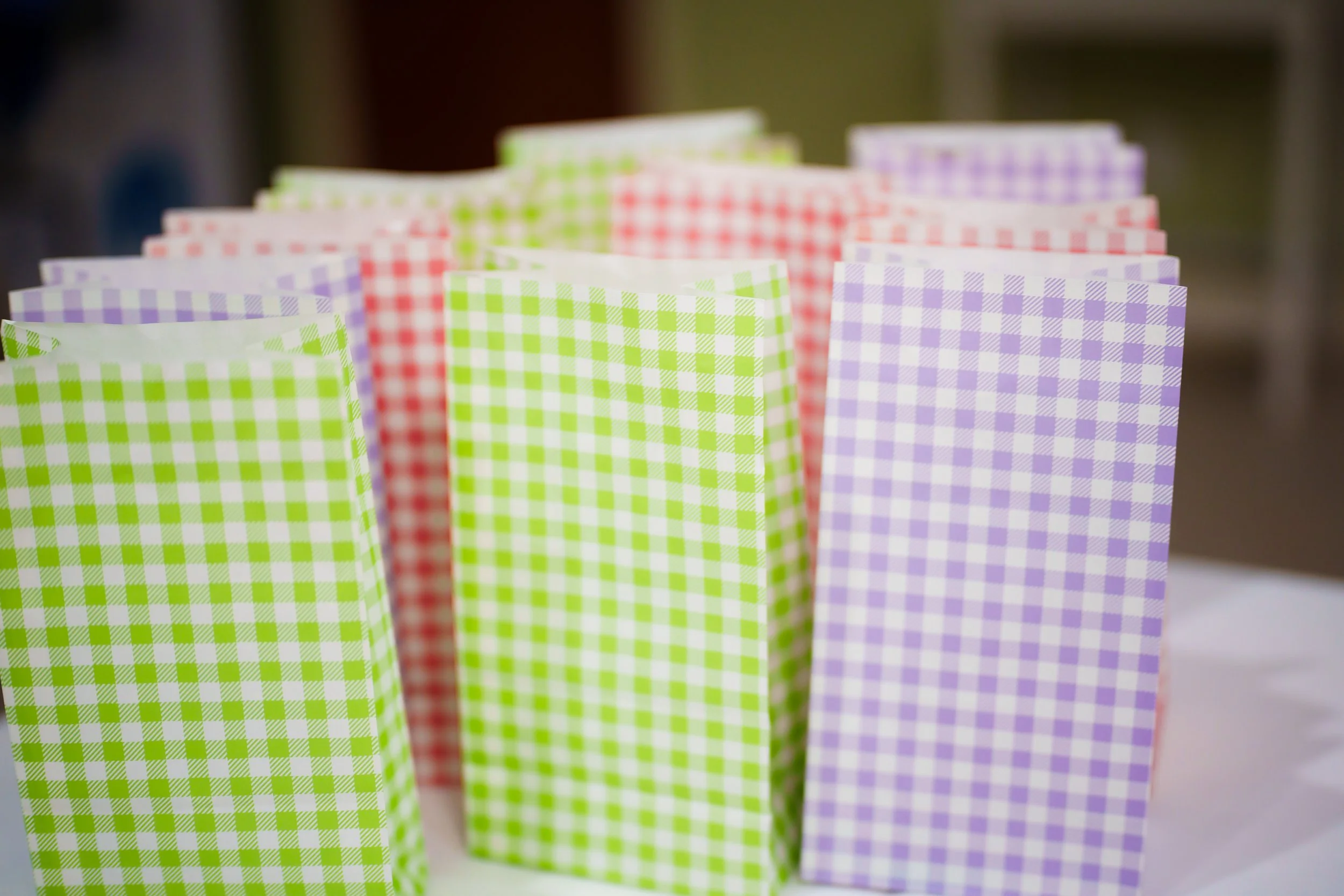 Colorful checkered paper bags in green, red, and purple.