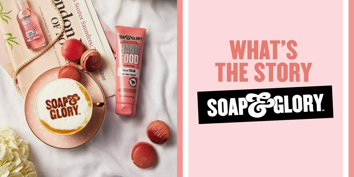 A flat lay of Soap & Glory skincare products, including a hand food cream, with macarons, a soap dish with soap, a pearl necklace, a book, and a flower, on a white cloth background. The right side features a pink background with bold text: 'WHAT'S TH