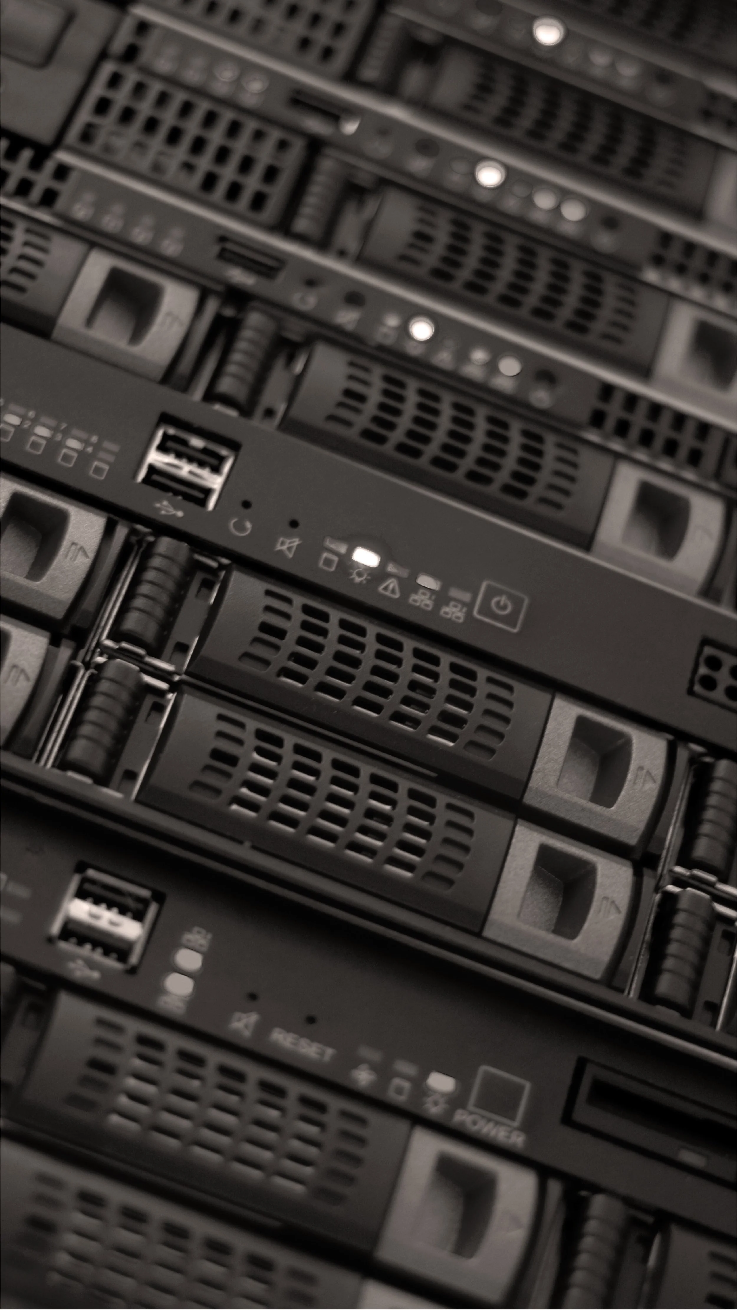 Close-up of multiple server racks with vents, ports, and indicator lights.