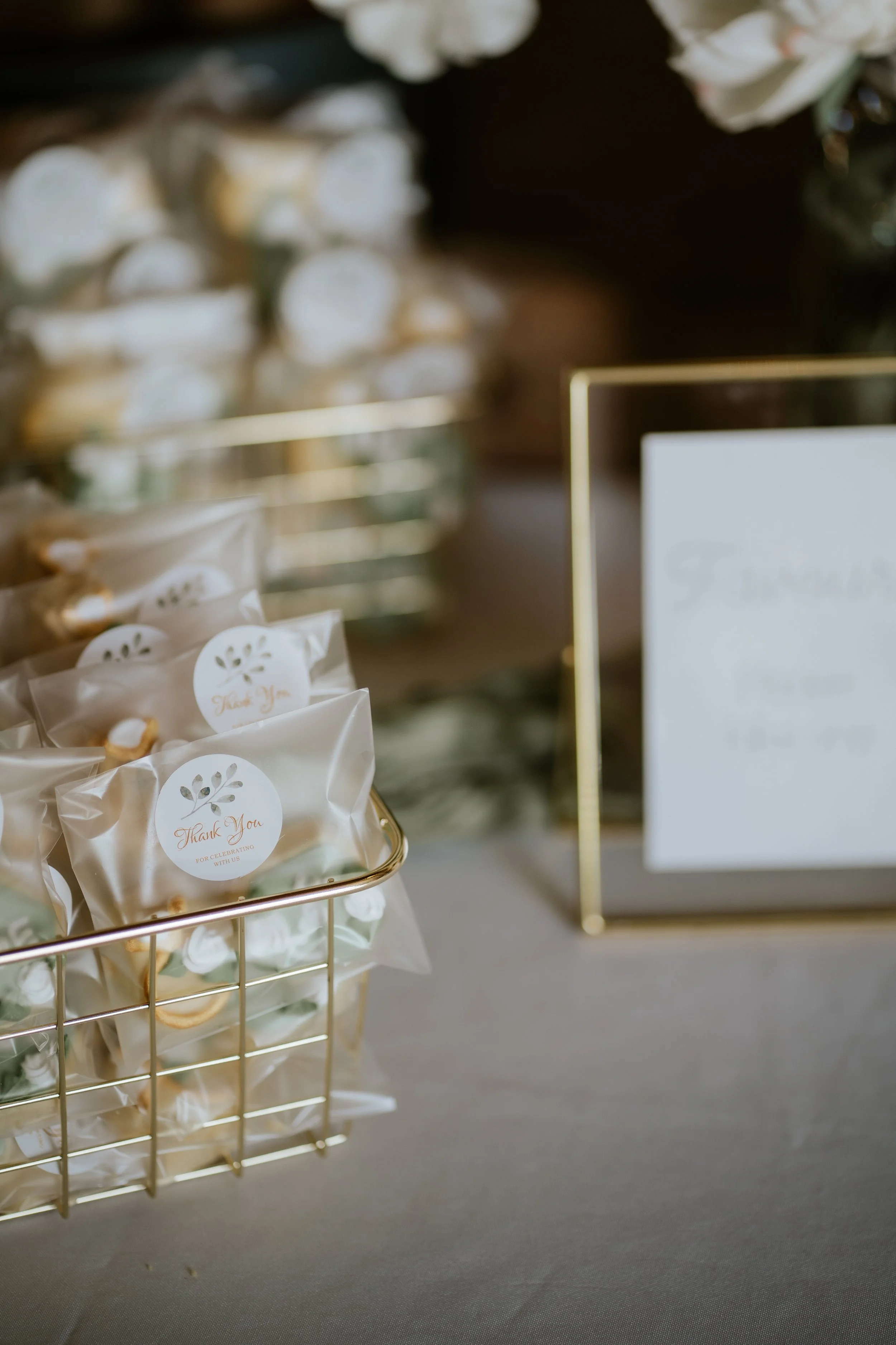 Thank you favors in small clear bags with 'Thank You' stickers on a table at an event.