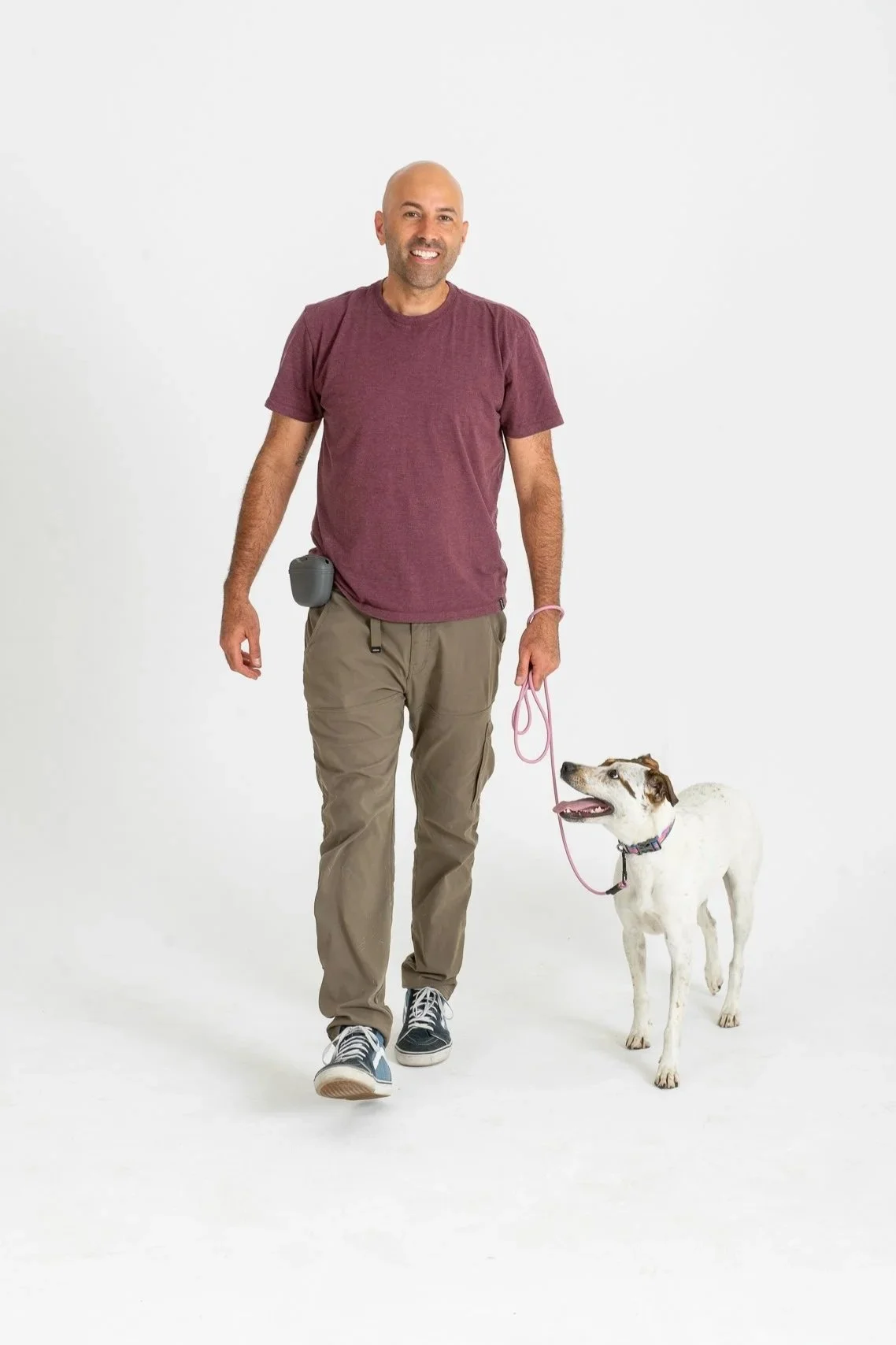 Alex Nieto, Denver dog trainer, having a calm walk with a dog.