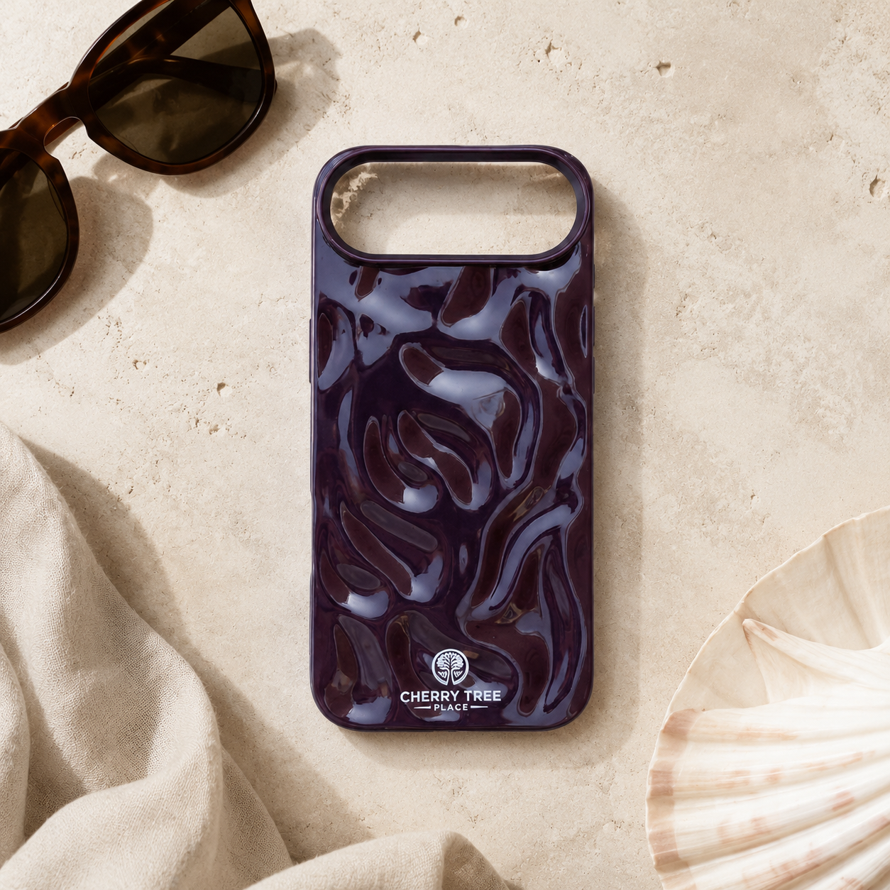 Glossy aubergine ripple case flat lay.png
