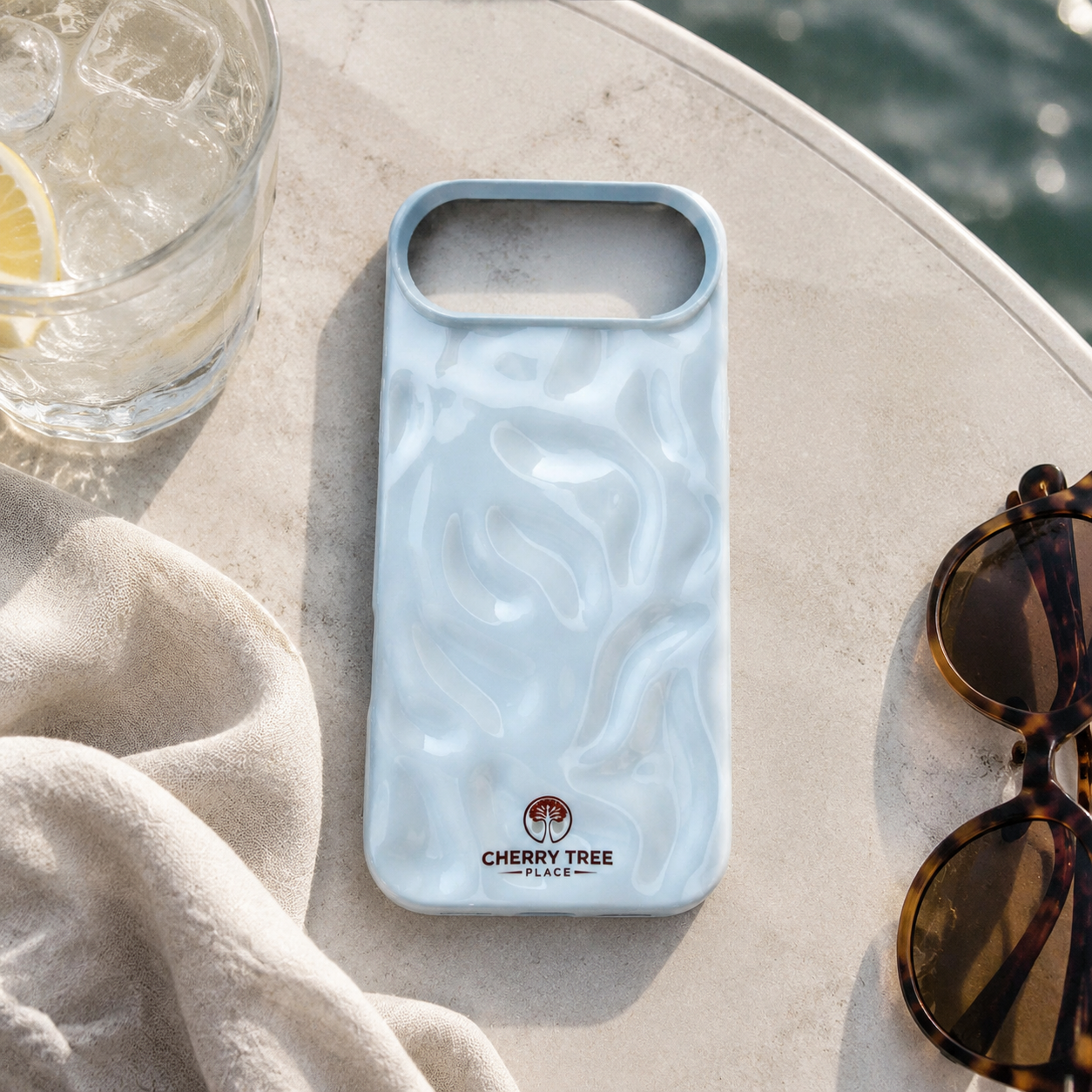 Pearlescent blue case at a seaside café.png