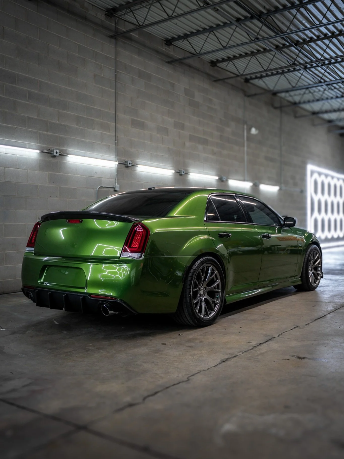 The 2012 Chrysler 300 came in ready for a full transformation, and we gave it a brand-new presence. Upgraded with a rear bumper taillight conversion to the 2018 style, a sleek rear spoiler, front bumper lip, a fresh rear diffuser, gloss black roof, a