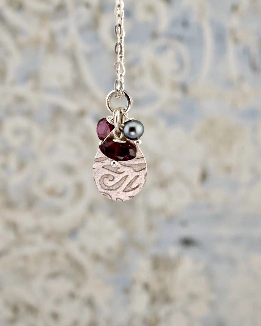 Silver Patterned Pendant with Garnets and a Black Pearl