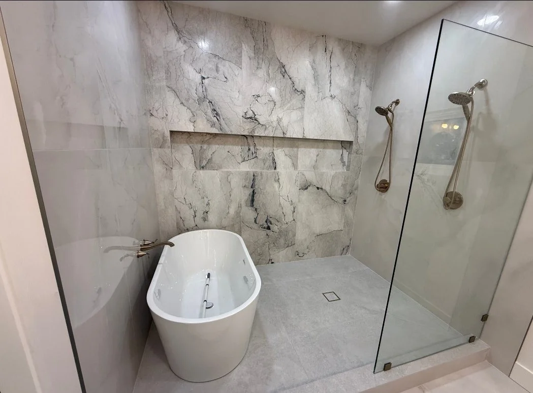 custom walk-in shower with freestanding tub in a modern bathroom remodel