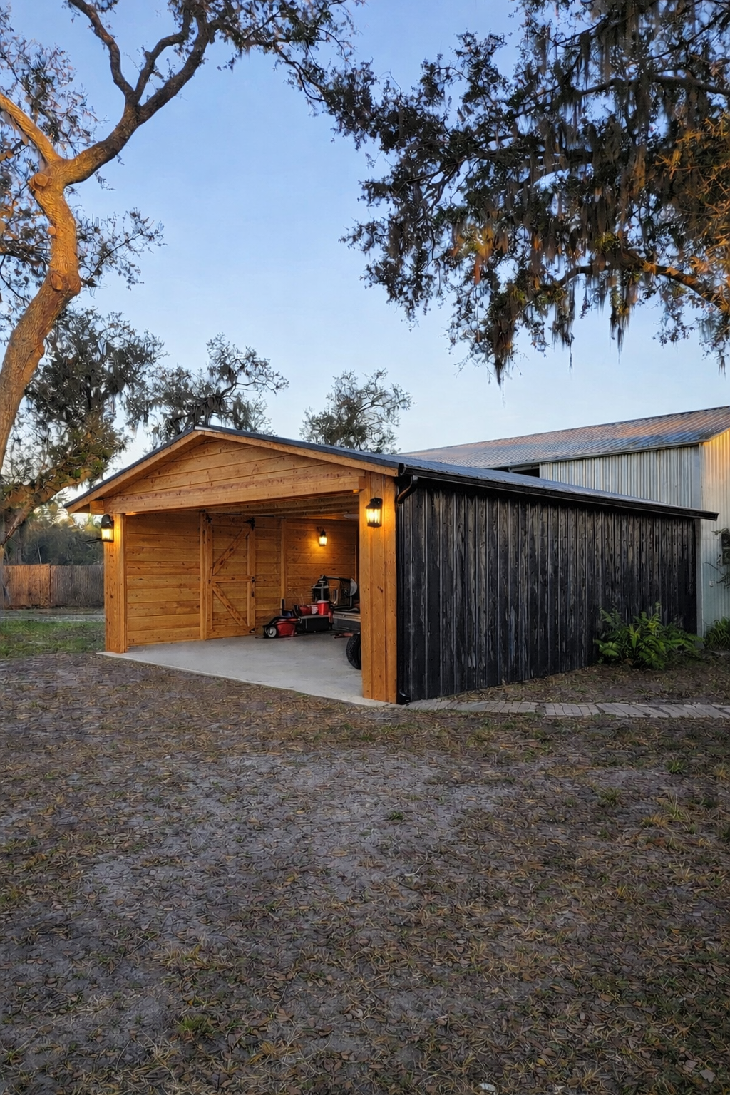 Carport converted into an enclosed detached garage with cedar gable end, corrugated metal siding, and finished interior walls