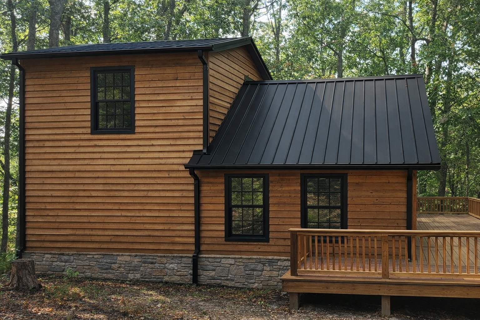 New construction vacation cabin featuring cedar siding, metal roof, stone veneer foundation, and expanded wood deck