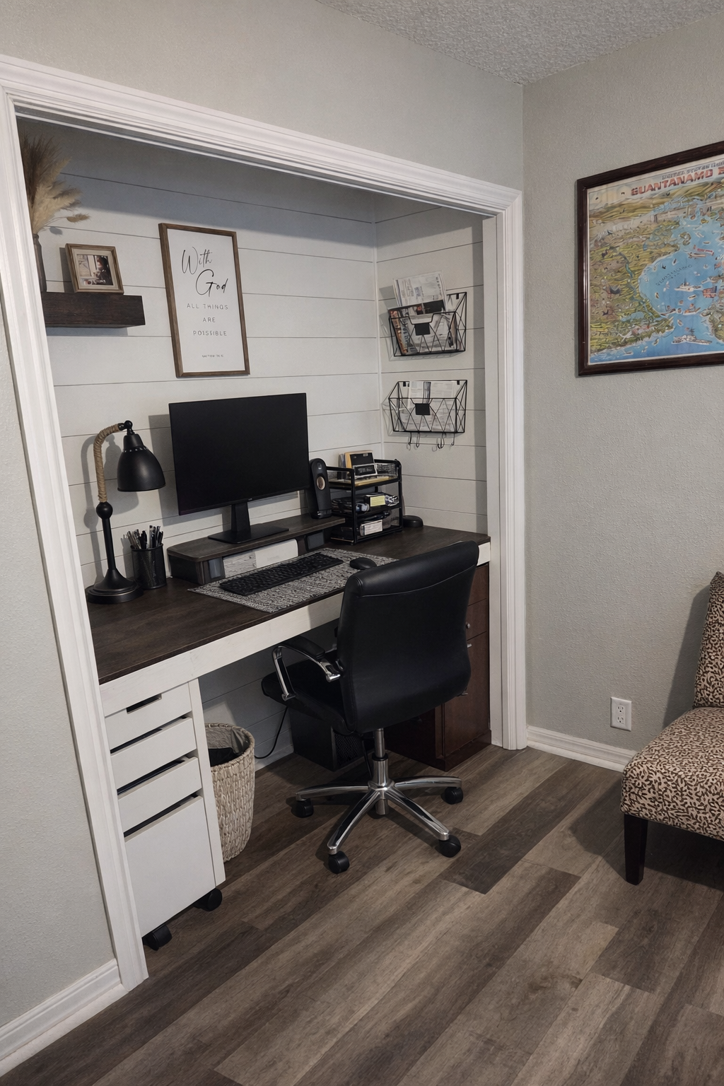 Closet converted into a space-saving home office workstation with built-in desk, shelving, and shiplap accent wall