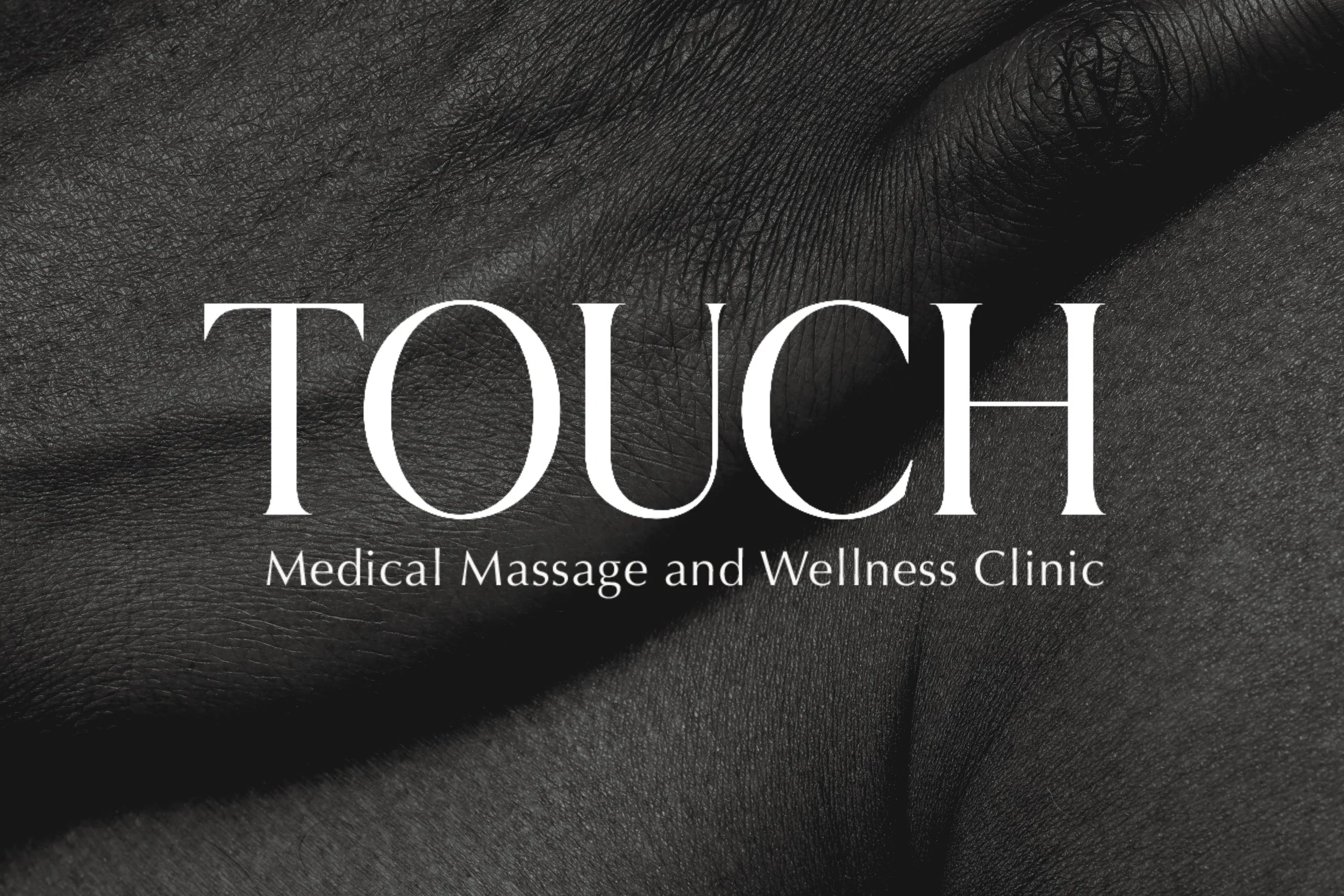 The image features a close-up of black textured leather and the text 'TOUCH Medical Massage and Wellness Clinic' overlaid in white.