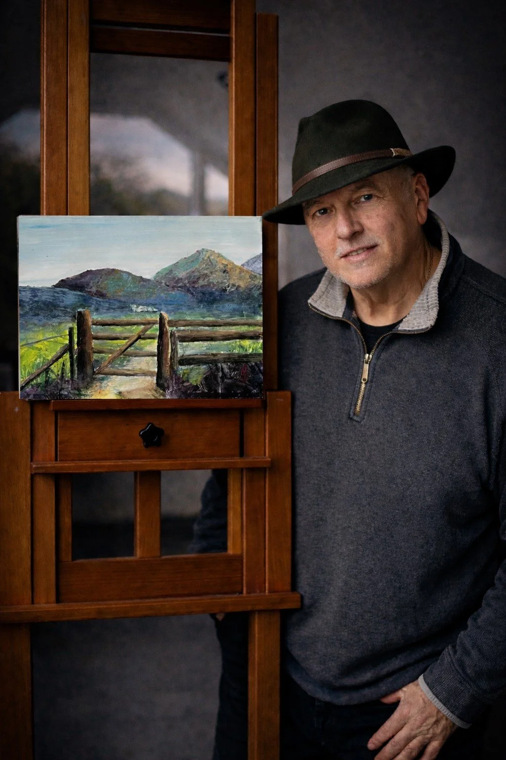 Andrew Bowers contemporary British landscape artist in studio with textured acrylic painting