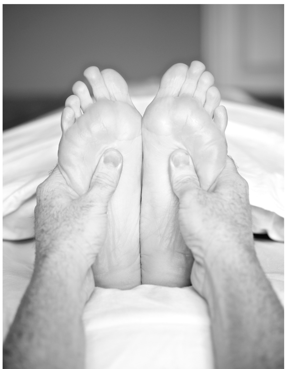Relaxation massage when the therapist is massage the bottoms of the feet.