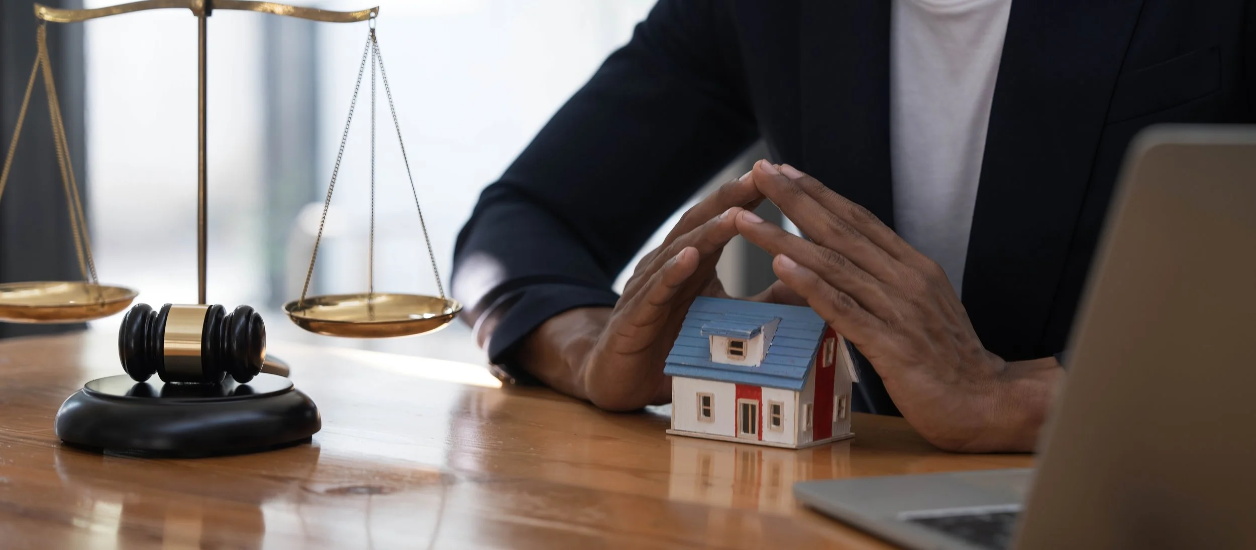 close-up-of-a-house-in-front-of-a-lawyer-holding-a-2025-01-16-13-26-32-utc.jpg