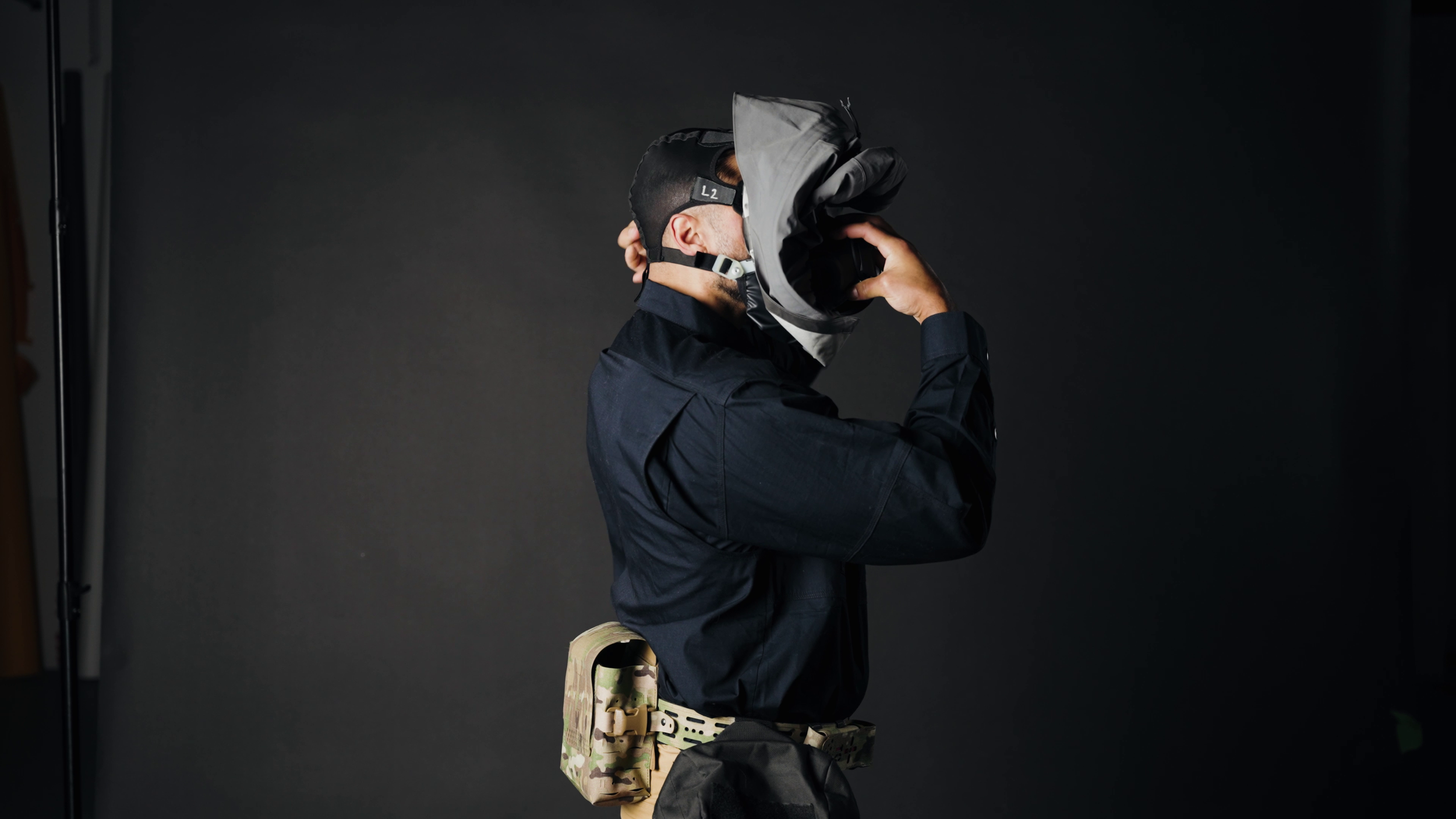 Side View of User Donning Head Harness