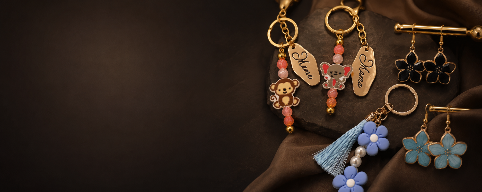 Collection of various jewelry pieces including earrings, necklaces, and charms with colorful beads, flowers, and animal designs displayed on a dark background and brown fabric