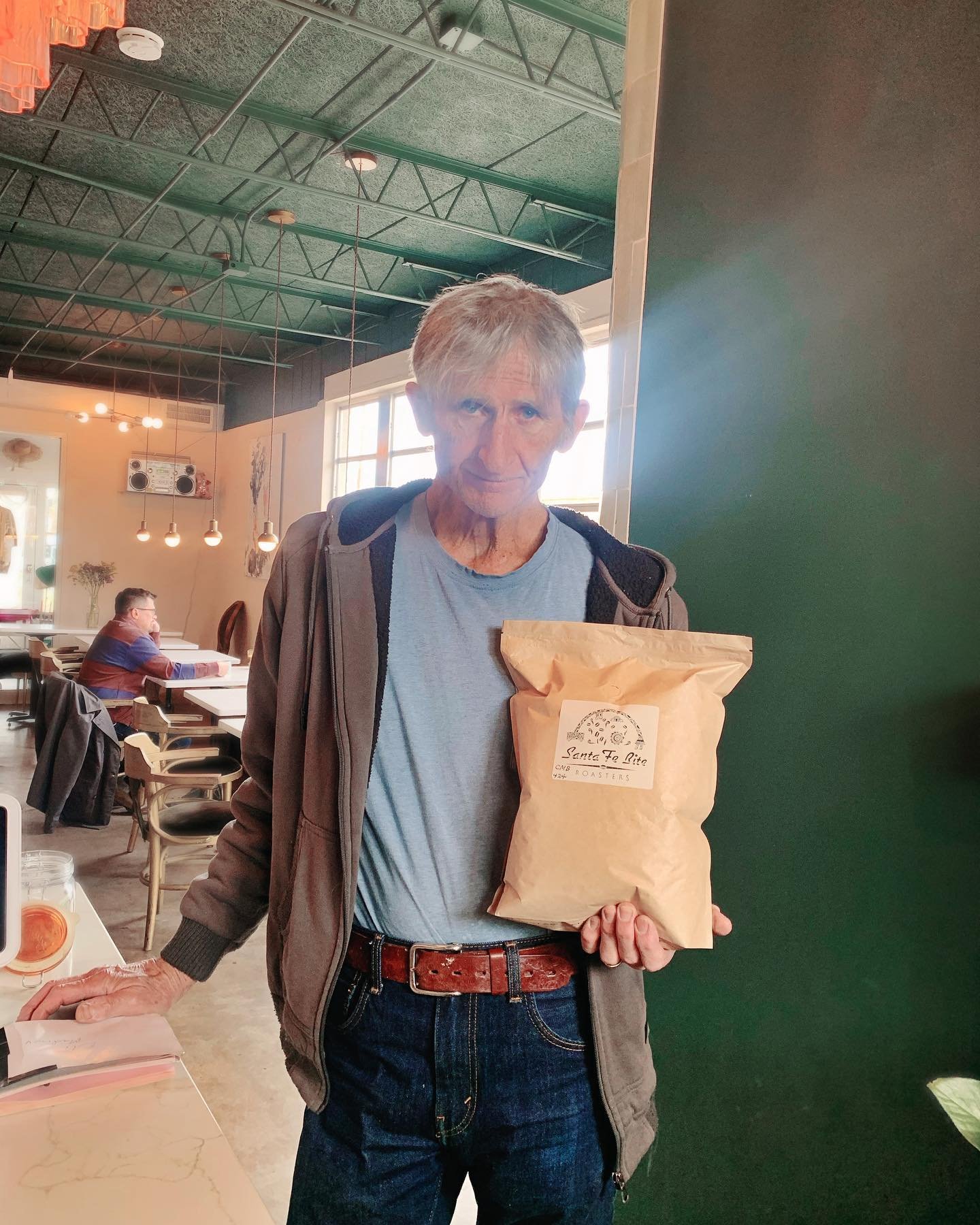 This is John he’s our hero ~ he roasts the coffee we serve proudly. The beans are from Kenya, grown organically by various families within a village where our distributor, Abraham, is from. John got involved with roasting because in his own wor