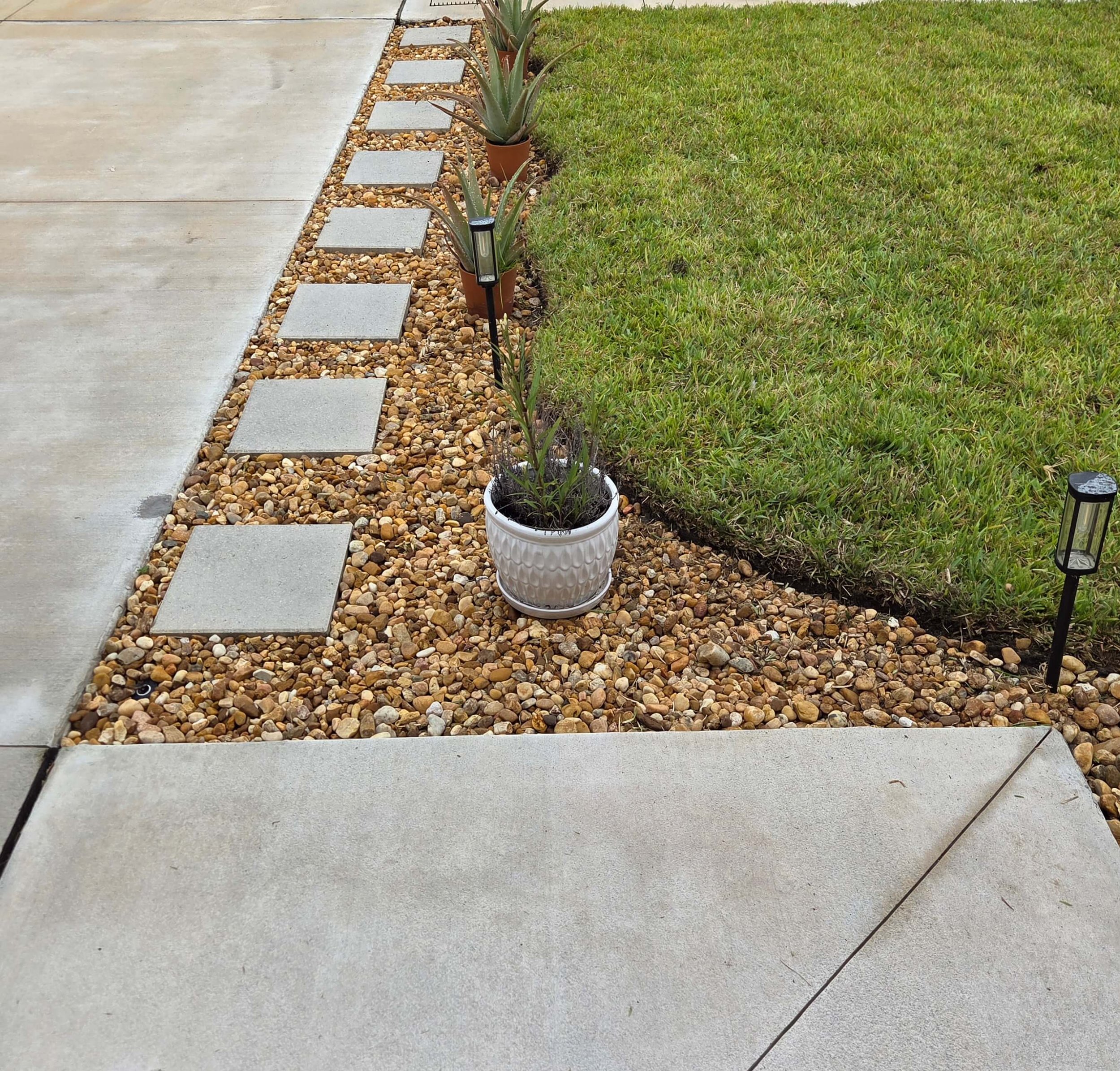 Landscape edging and rock bed installation improving curb appeal