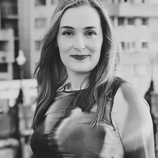 A woman looking straight at the camera and smiling.