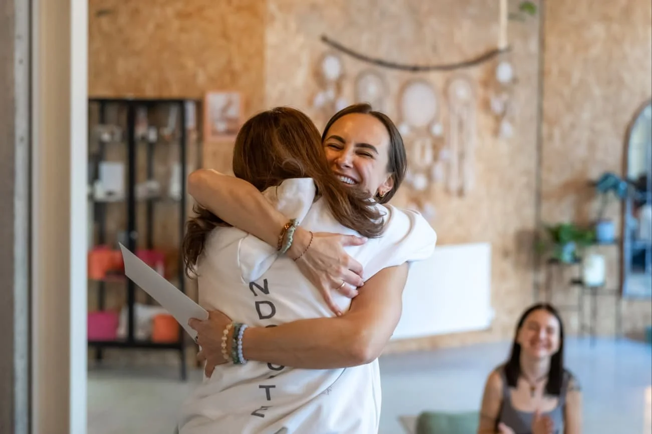 Facilitator is happy hugging with certificate in hands after Life-Force facilitator training in London