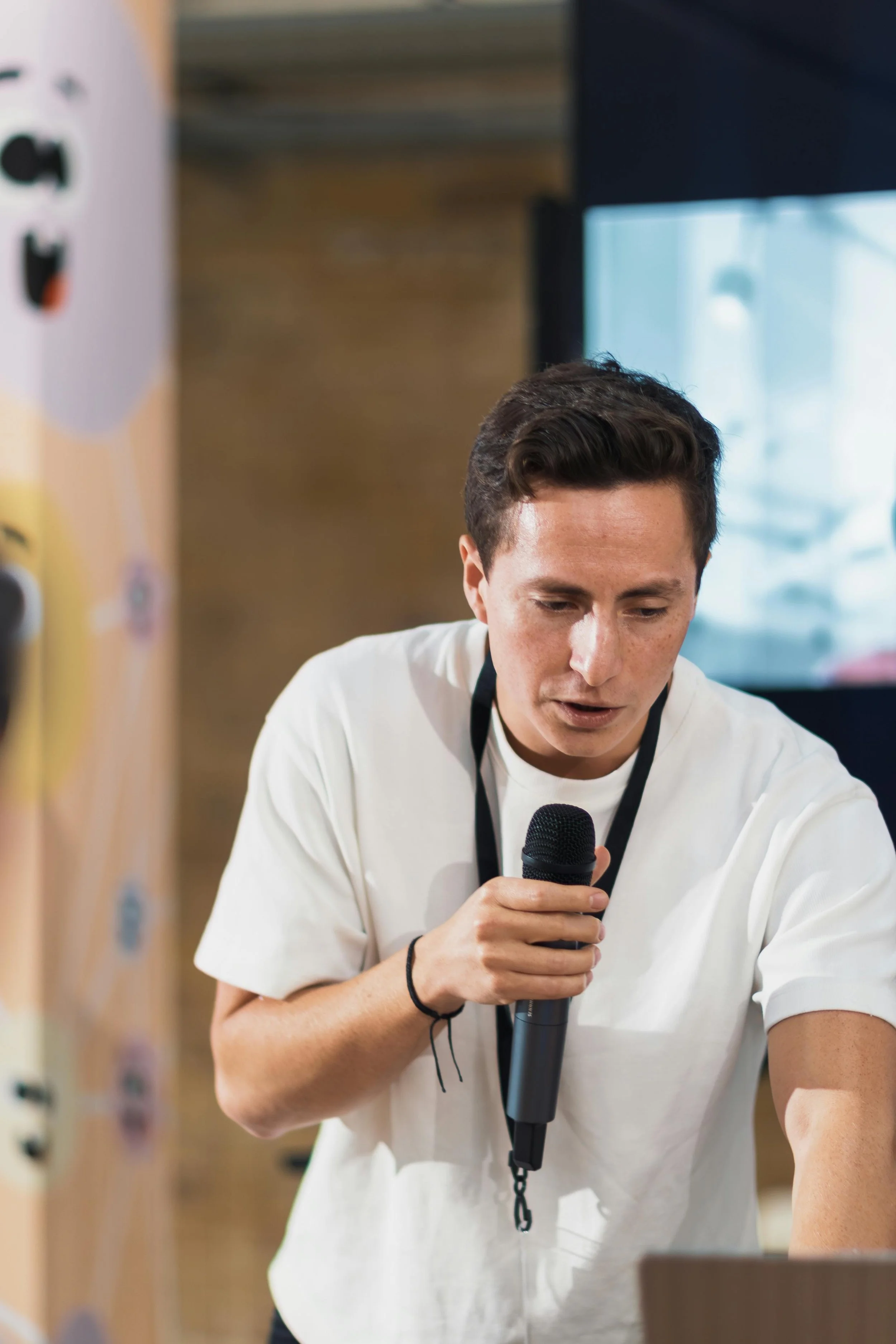A podcaster interviews a guest who speaks into a microphone.