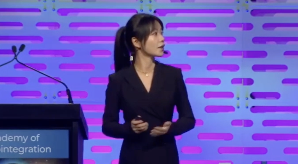 A young woman models good breathing techniques for public speaking.