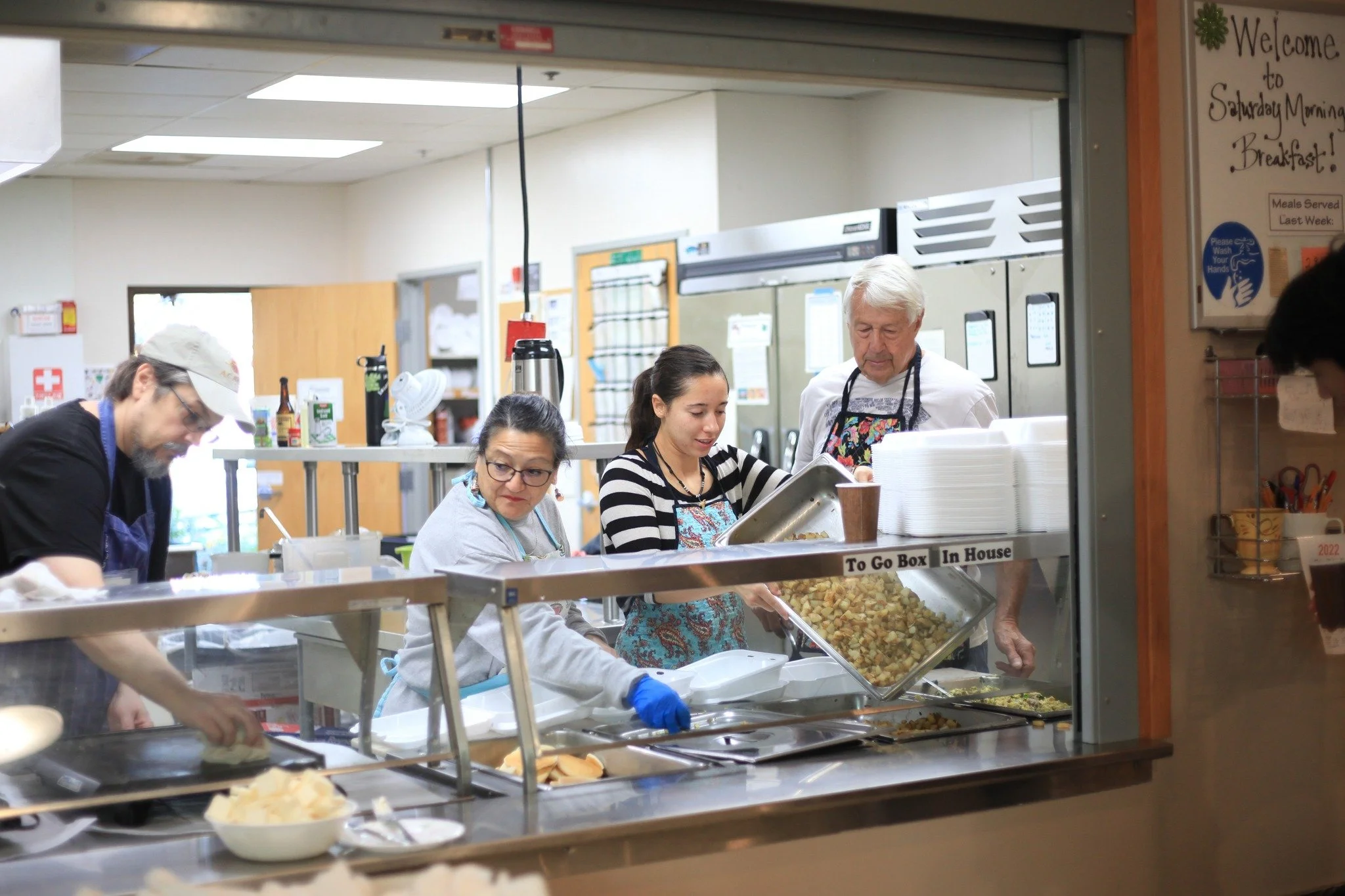 Volunteers serving food at Saturday Morning Breakfast.