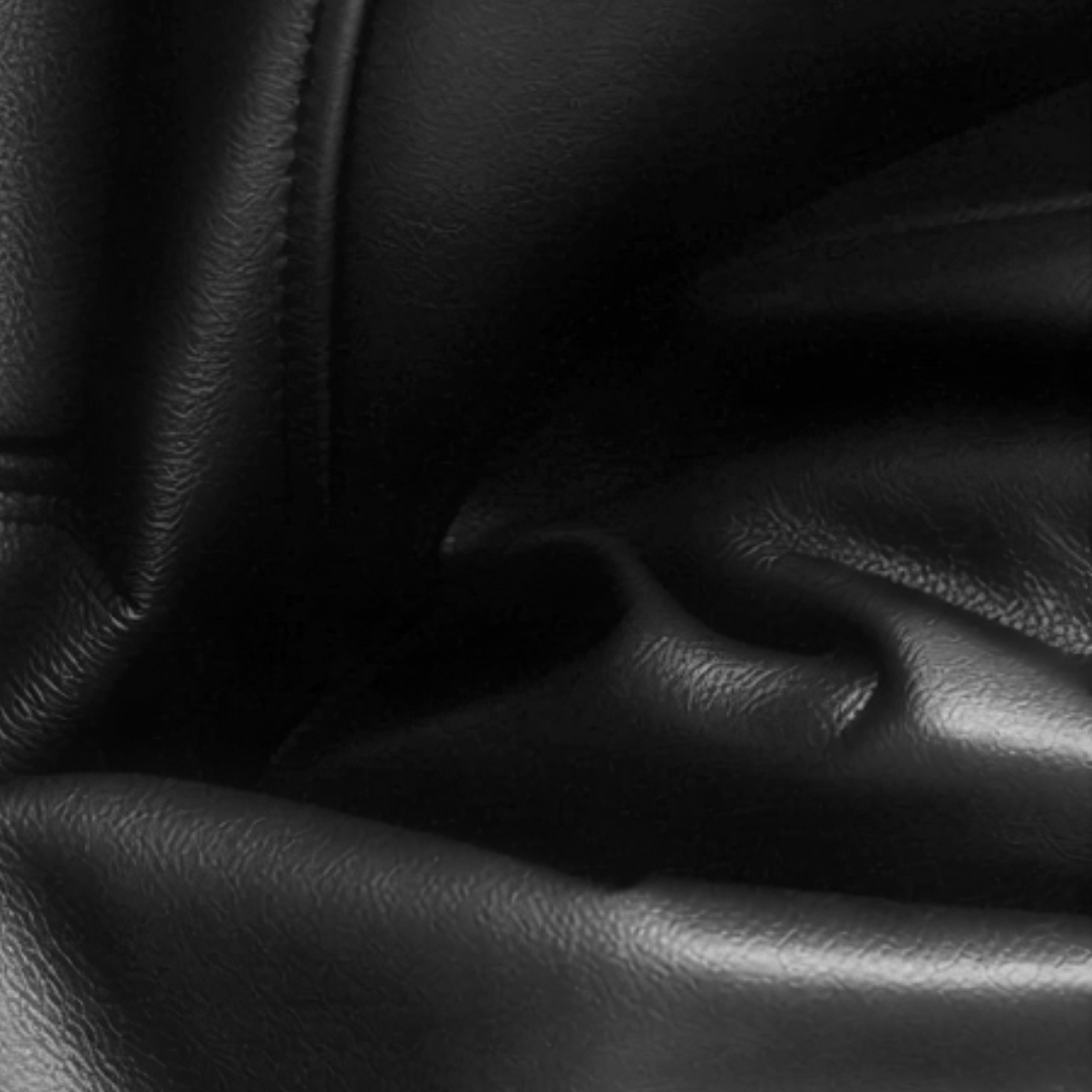 Dark leather texture close-up, base note ingredient visual for Born in Roma Idyllic Sunrise Uomo Valentino ScentLab concept by WSSC