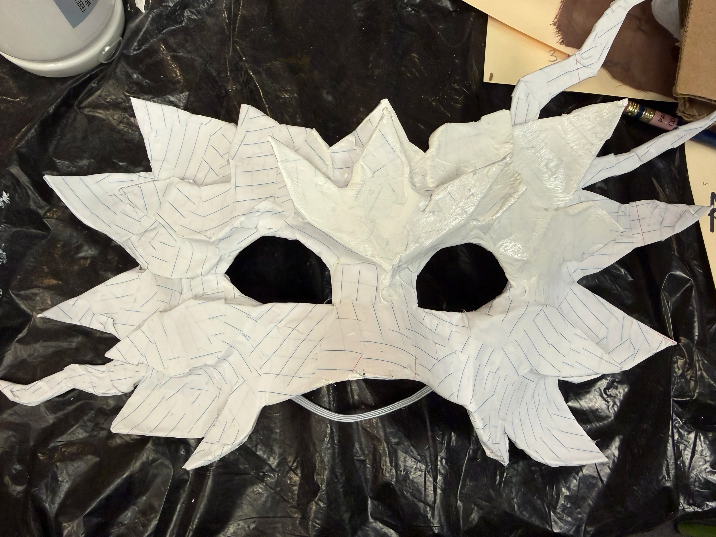The bases for each of these masks were pre-built mask bases, which I built up with thin foam, paper, and hot glue for raised detailing